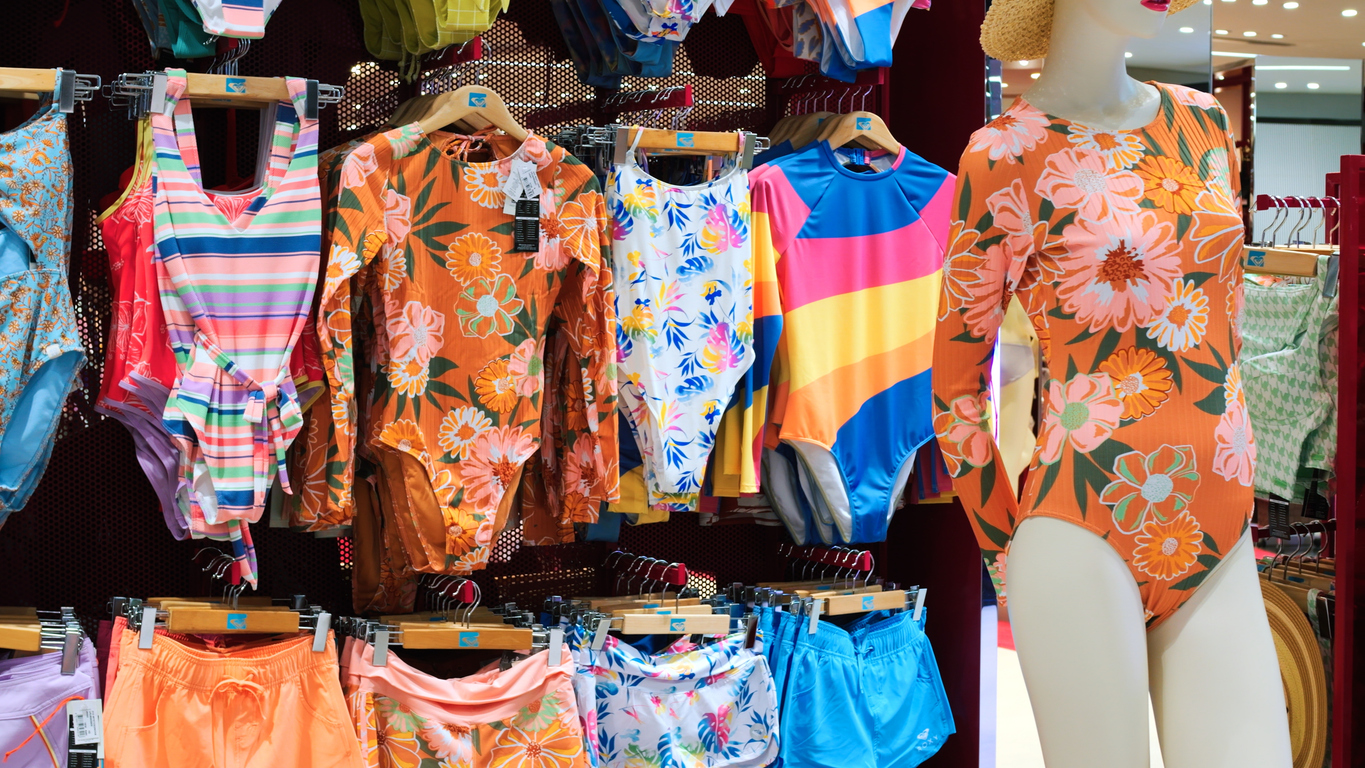 Cinematic video: women's colored swimwear for on display in store. Slow motion of women's summer swimwear on display in store. Concept: get ready for bathing season - buy a beautiful women's swimwear.