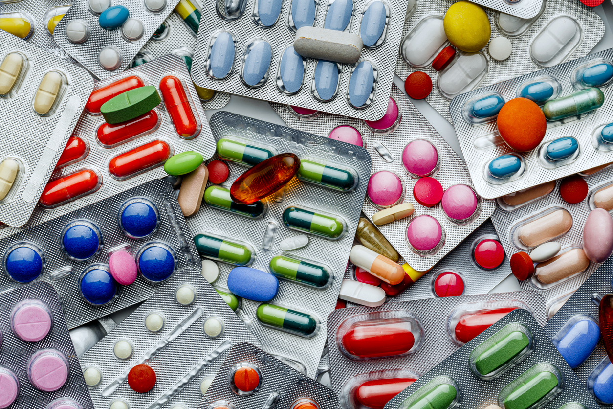 Health themes: Background of a large group of assorted capsules, pills and blisters. Drug abuse.