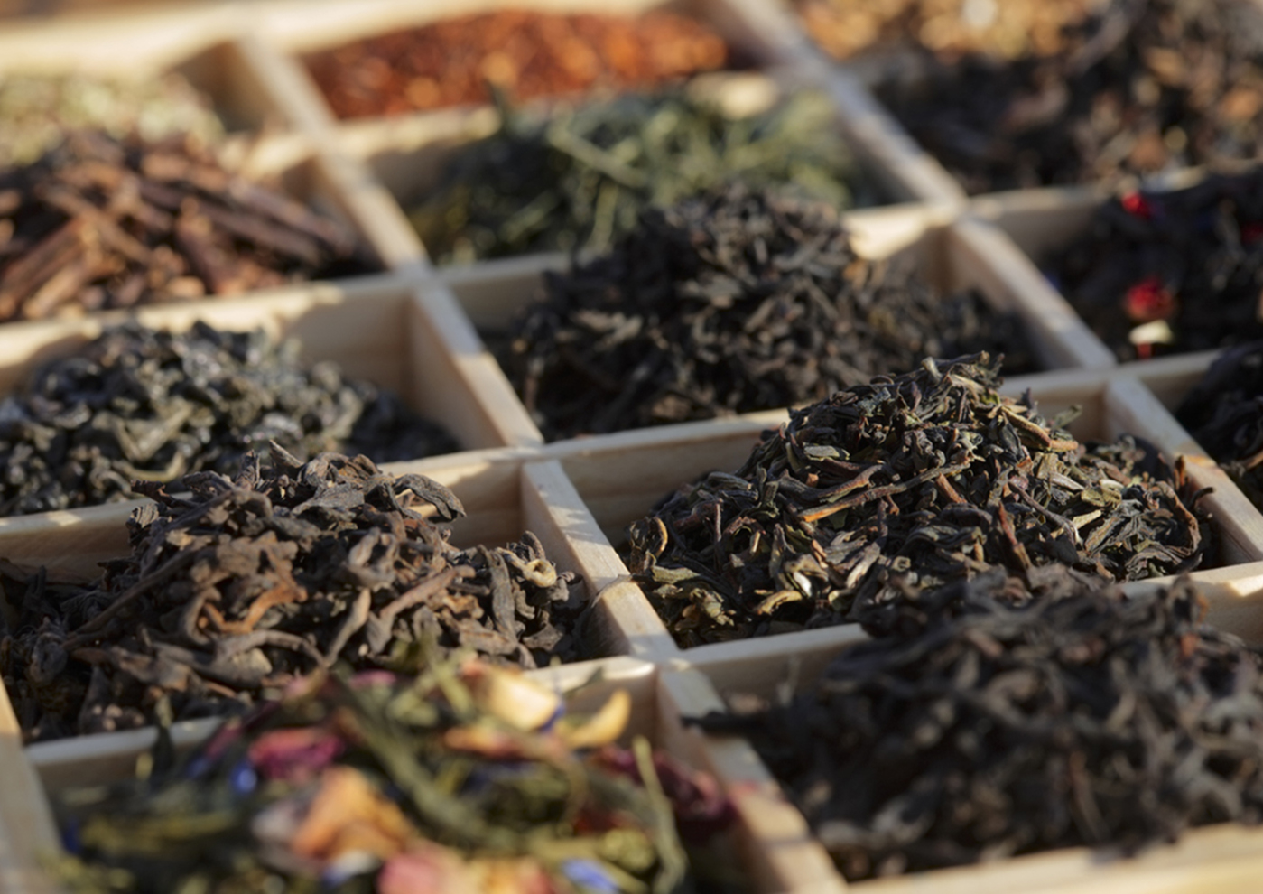 "Varieties of tea in a wood box. Similar photos on my portfolio. Focus in centre (Darjeeling, Lapsang Souchong)"