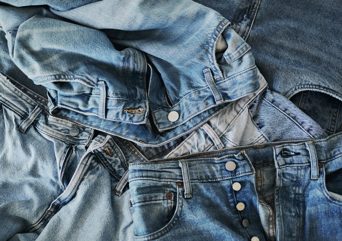 A pile of blue denim jeans. Stock photo