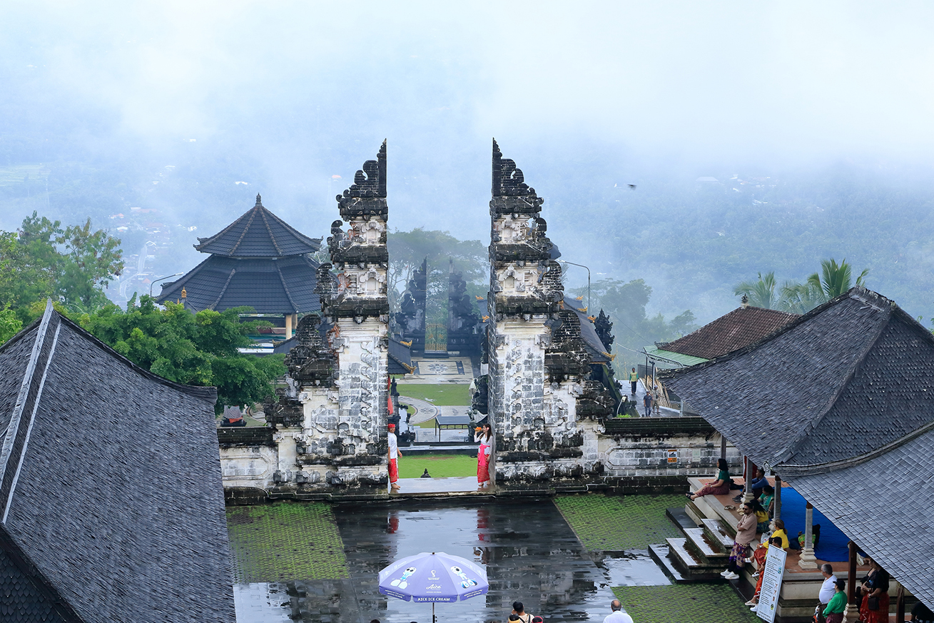 Bali, Indonesia - February 05 2024: people visit and enjoy the Lempuyang Luhur temple in Bali on a rainy day