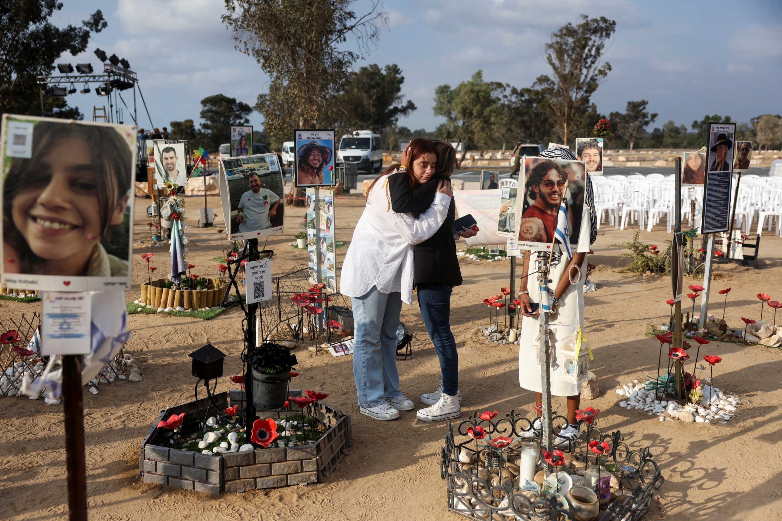 People comfort each other, as they visit the site of the Nova festival, where partygoers were killed and kidnapped during the October 7 attack by Hamas from Gaza, the day before the first anniversary of the attack, in Reim, southern Israel, October 6, 2024. REUTERS