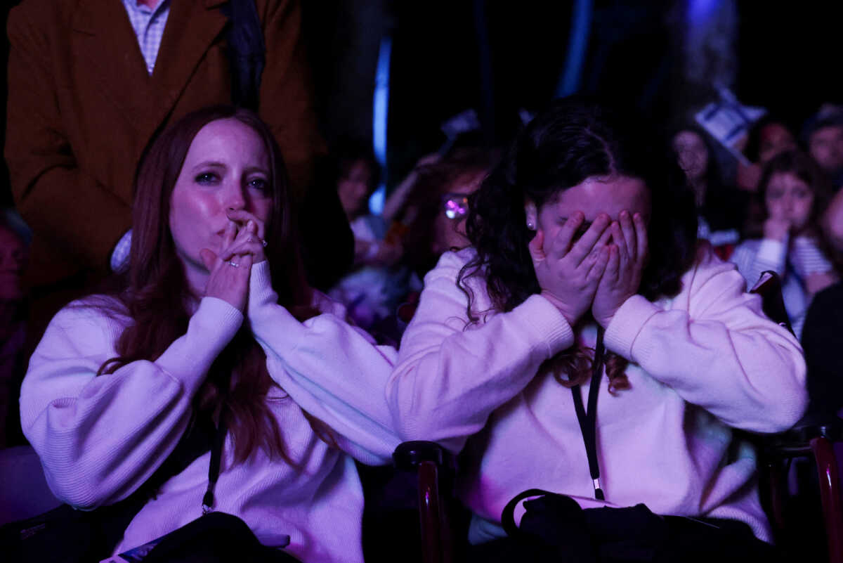 Women grieve in the crowd at an event to mark the anniversary of the October 7 Hamas attacks on Israel, in Central Park, New York City, U.S., October 7, 2024.  REUTERS