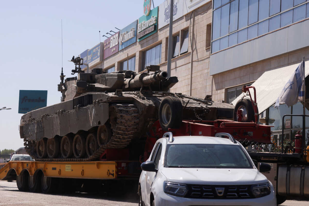 An Israeli army tank is transported, amid cross-border hostilities between Hezbollah and Israel, in northern Israel, September 26, 2024. REUTERS