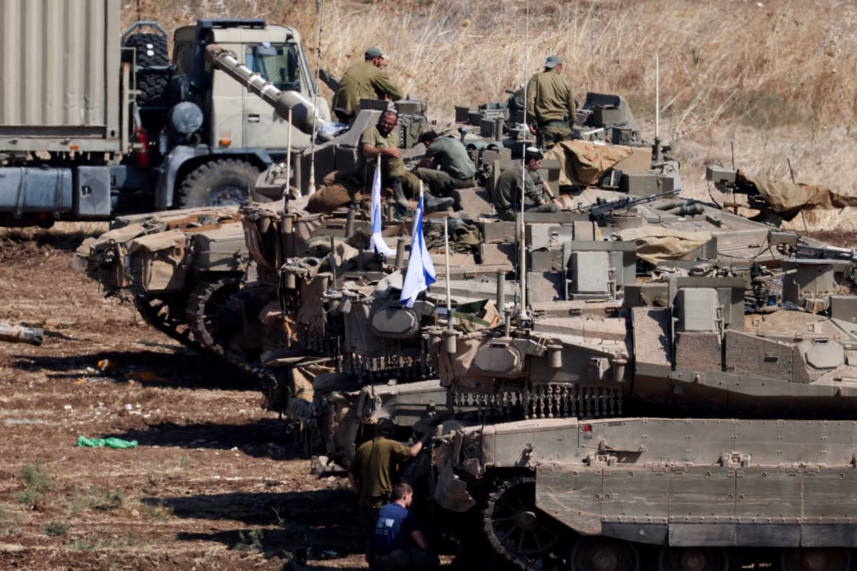 Israeli armoured military vehicles are arranged in formation, amid cross-border hostilities between Hezbollah and Israel, in northern Israel, September 30, 2024. REUTERS