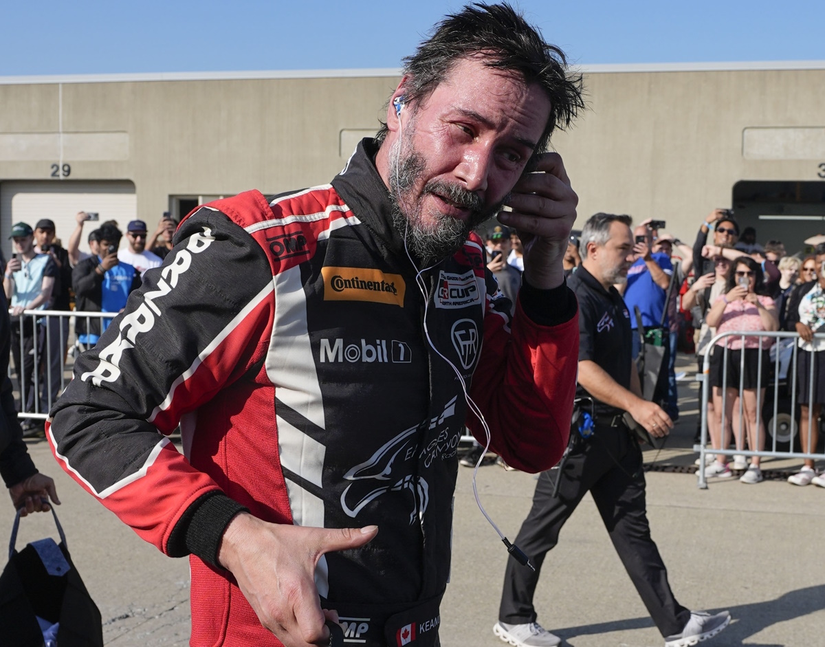 Keanu Reeves walks in the garage area following a GR Cup Series auto race at Indianapolis Motor Speedway, Saturday, Oct. 5, 2024, in Indianapolis. (AP Photo