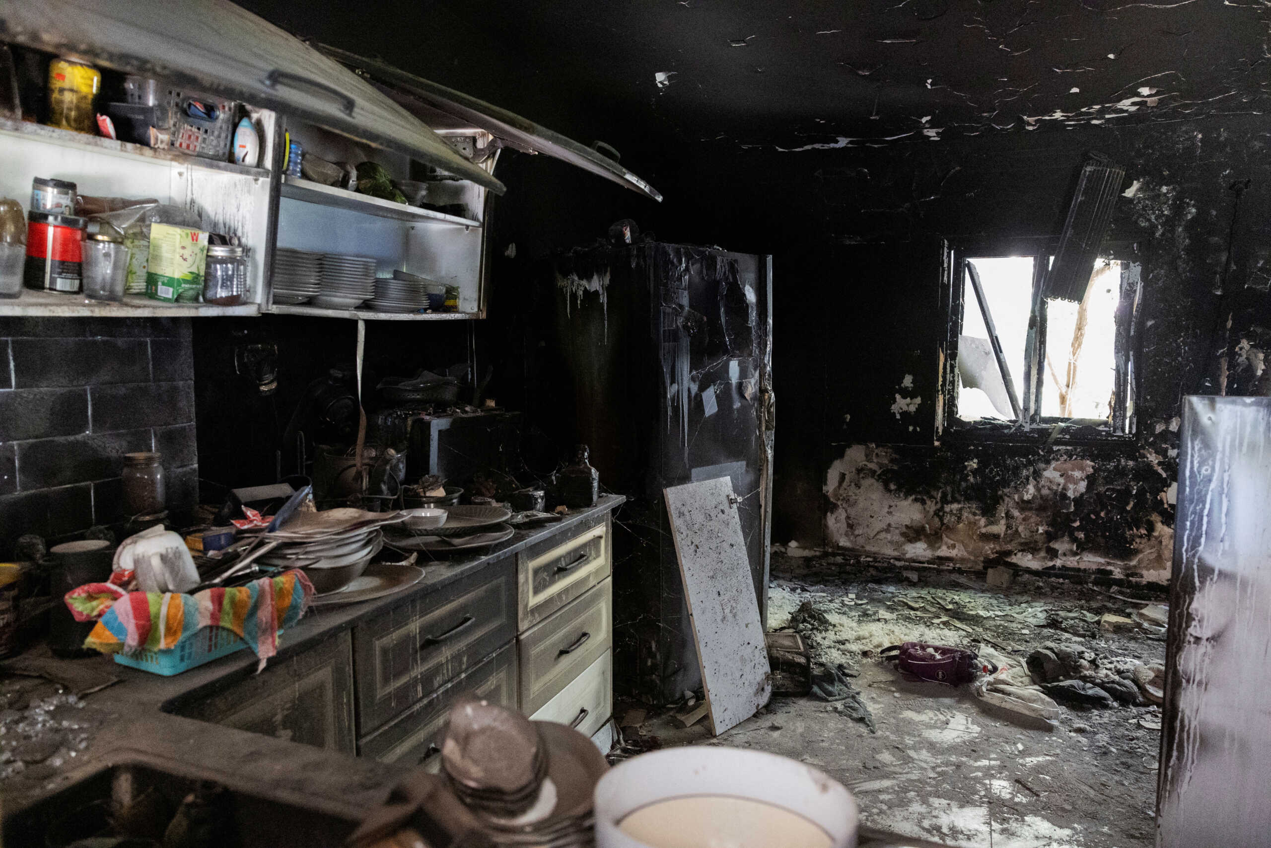 The charred remains of a kitchen are seen, nearly a year since the deadly October 7 attack by Hamas, in Kibbutz Nir Oz, southern Israel, September 30, 2024. REUTERS