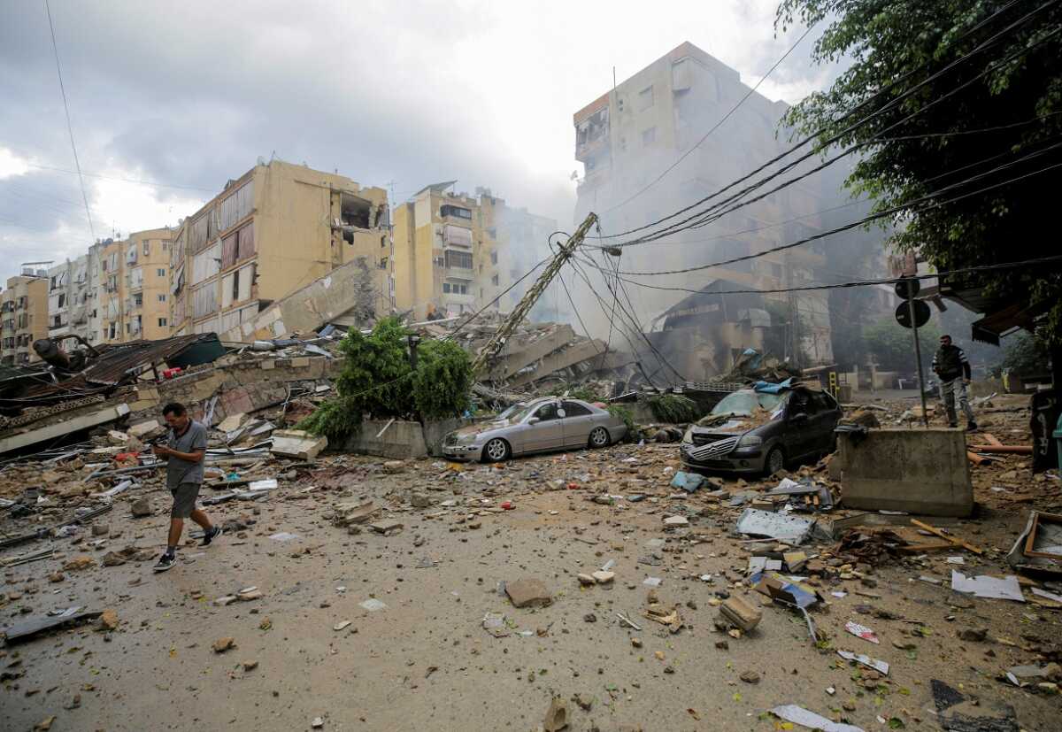 A man walks near damaged buildings, in the aftermath of Israeli strikes on Beirut's southern suburbs, Lebanon October 1, 2024.  REUTERS