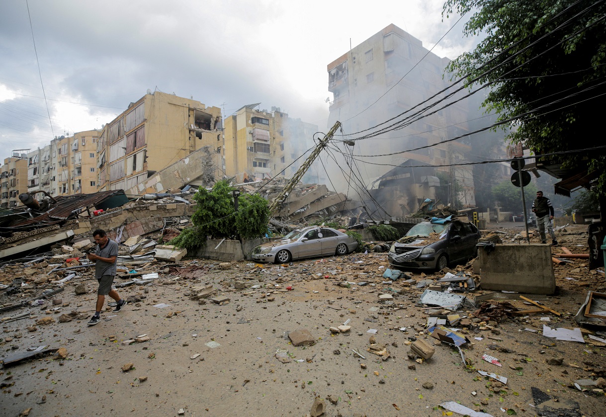 A man walks near damaged buildings, in the aftermath of Israeli strikes on Beirut's southern suburbs, Lebanon October 1, 2024.  REUTERS