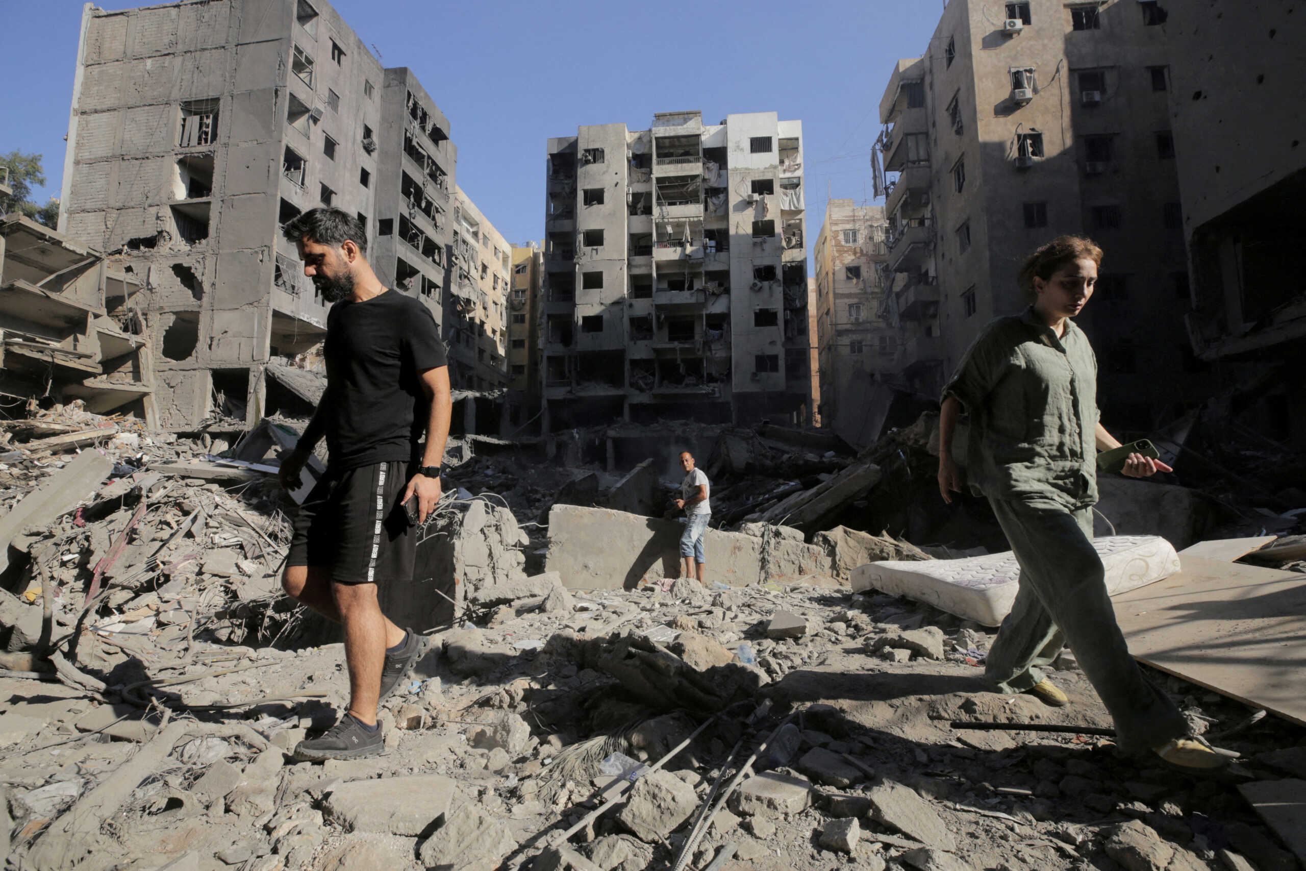 FILE PHOTO: People walk on the rubble at the site of the Israeli airstrike that killed Lebanon's Hezbollah leader Sayyed Hassan Nasrallah on Friday, in Beirut's southern suburbs, Lebanon, September 29, 2024.   REUTERS