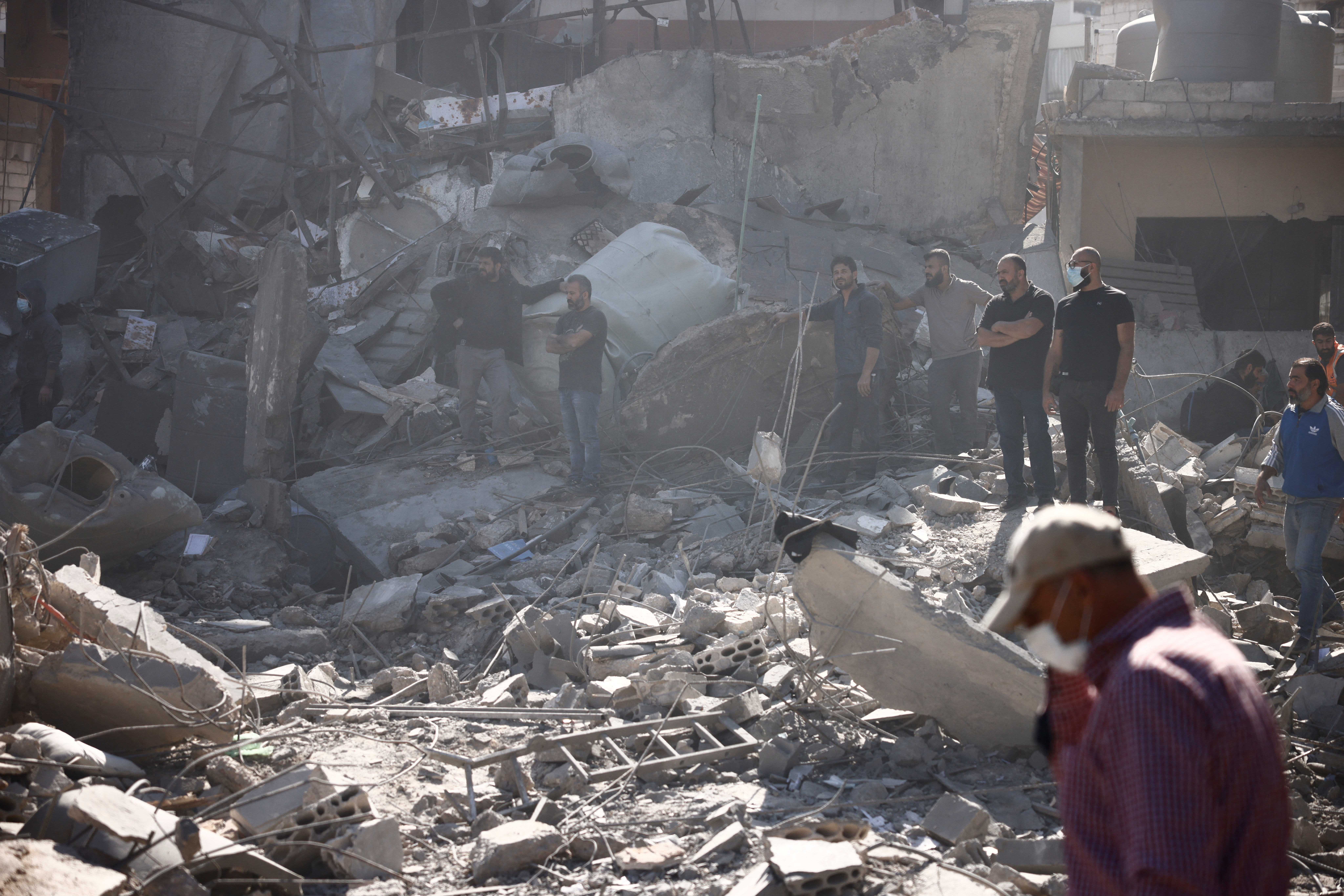 People inspect damage at the site of an Israeli strike near Beirut's Rafik Hariri University Hospital, amid ongoing hostilities between Hezbollah and Israeli forces, in Beirut, Lebanon October 22, 2024. REUTERS