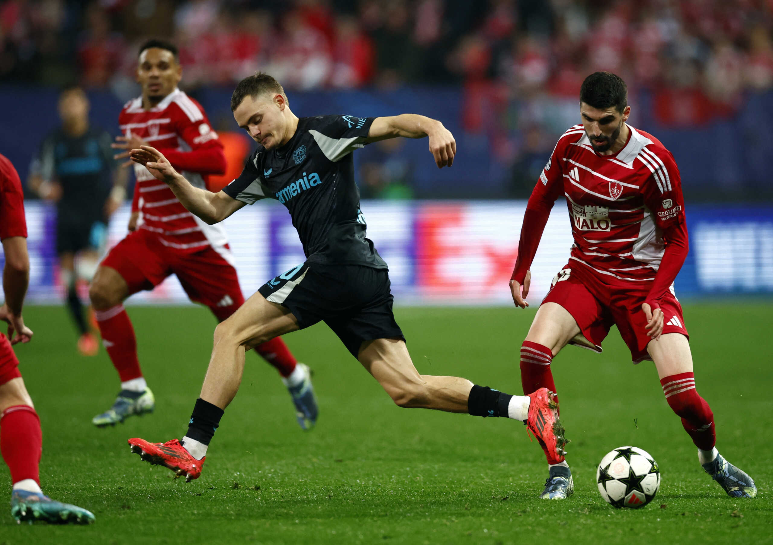 Soccer Football - Champions League - Brest v Bayer Leverkusen - Stade du Roudourou, Guingamp, France - October 23, 2024 Bayer Leverkusen's Florian Wirtz in action with Brest's Pierre Lees-Melou REUTERS