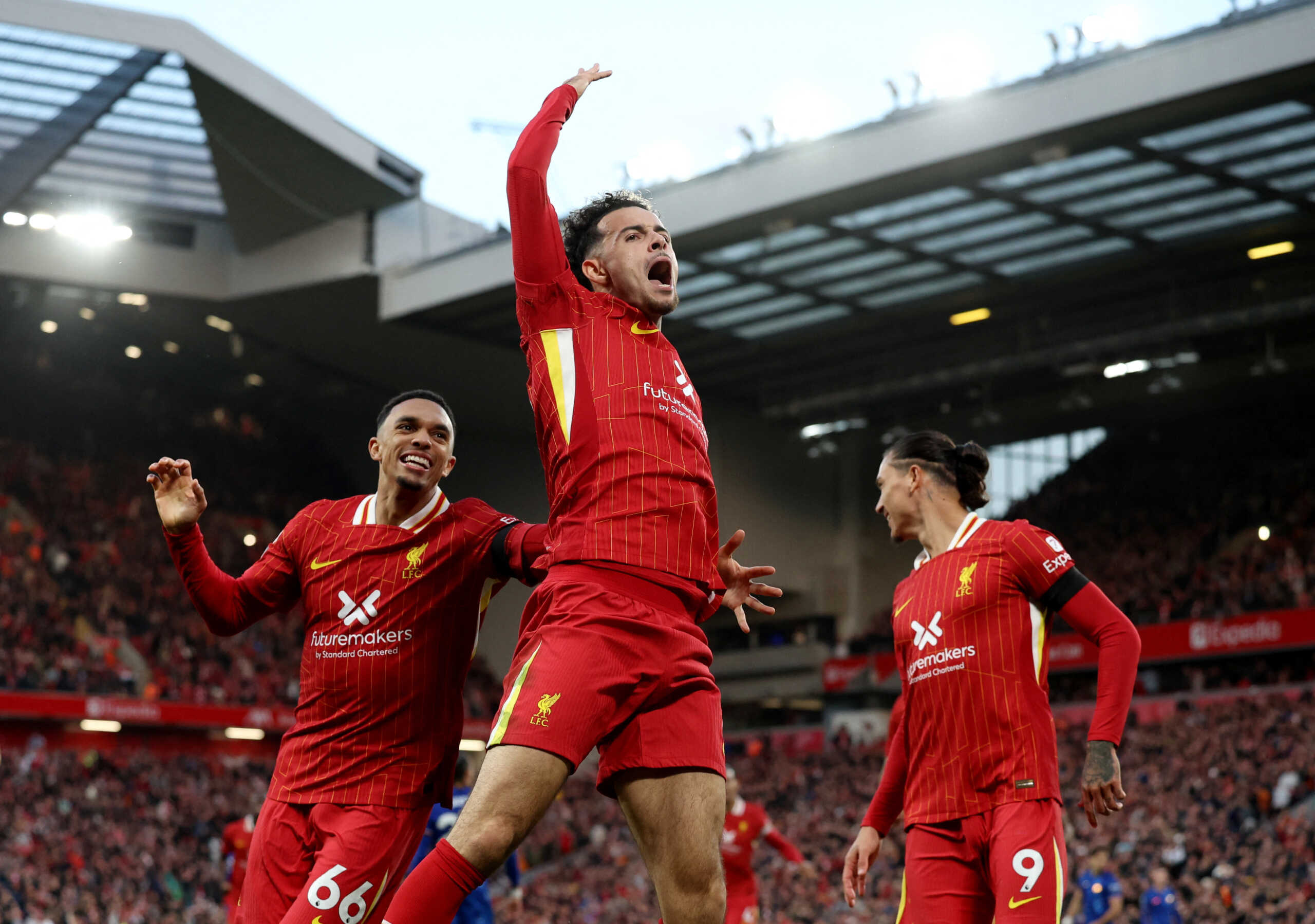 Soccer Football - Premier League - Liverpool v Chelsea - Anfield, Liverpool, Britain - October 20, 2024 Liverpool's Curtis Jones celebrates scoring their second goal with Trent Alexander-Arnold and Darwin Nunez REUTERS