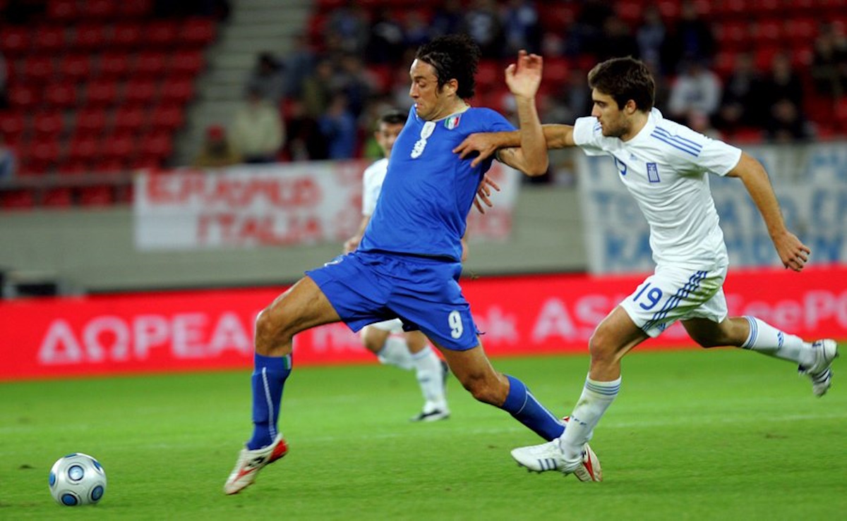 epa01555402 Greece's Sokratis Papastathopoulos (R) fights for the ball with Italy's Luka Toni (L) during their international friendly soccer match, at the Karaiskaki Stadium in Athens, Greece, 19 November 2008.  EPA