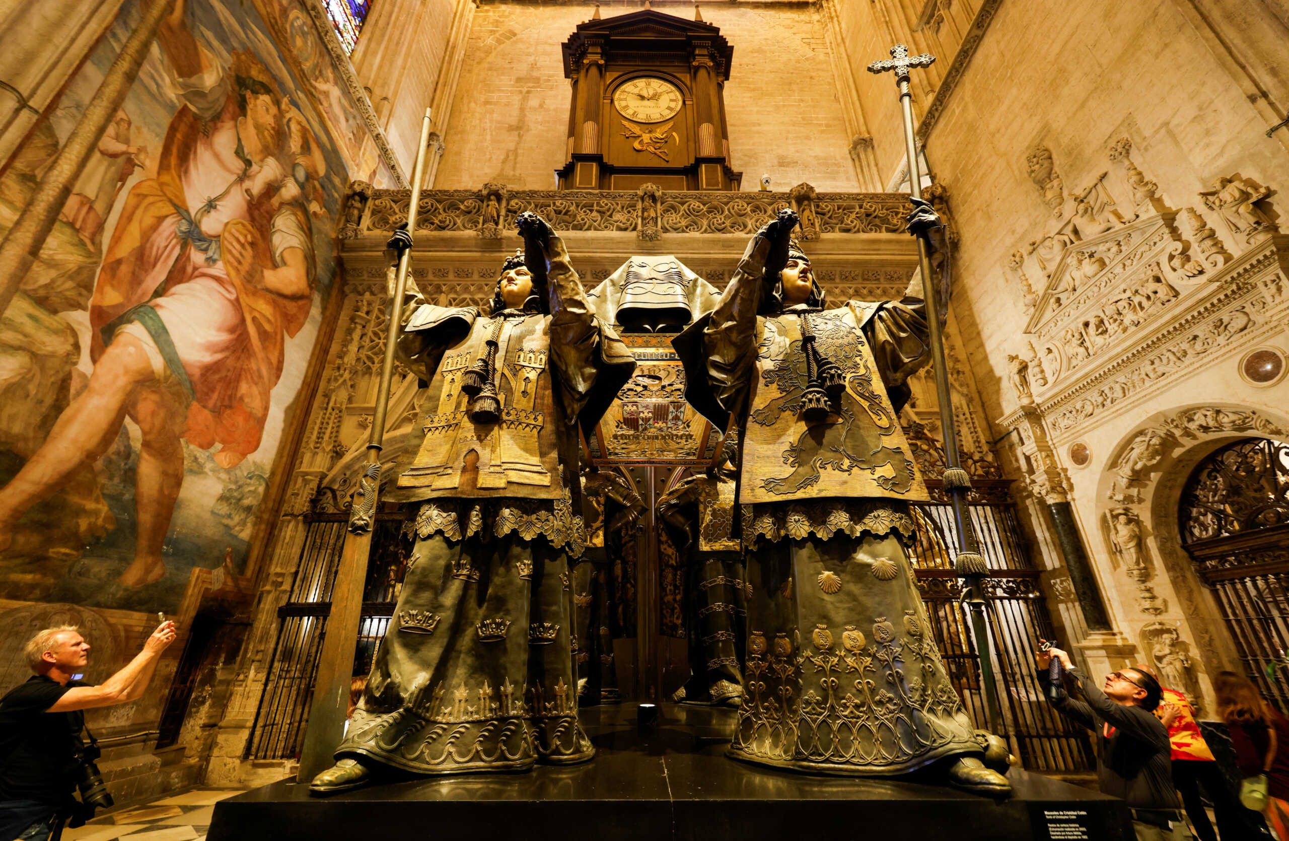 People visit the mausoleum of Christopher Columbus in the cathedral of Seville, Spain, October 11, 2024. REUTERS