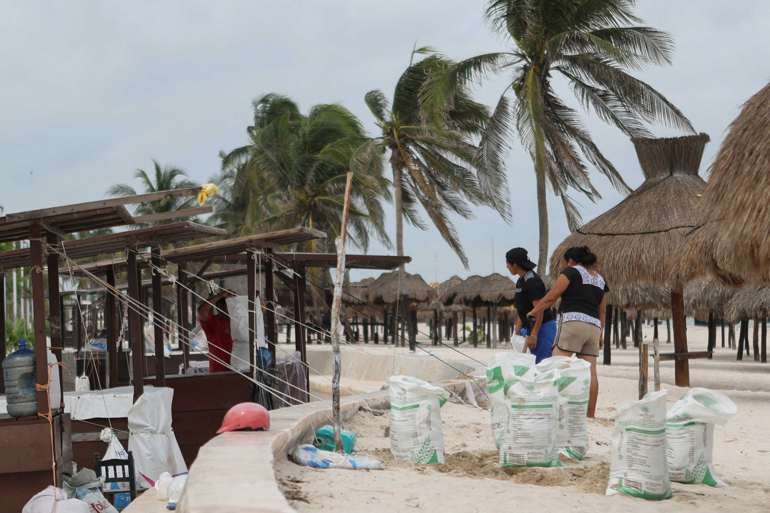 People fortify structures along the beach with sandbags as Hurricane Milton advances, in Progreso, Mexico, October 7, 2024. REUTERS