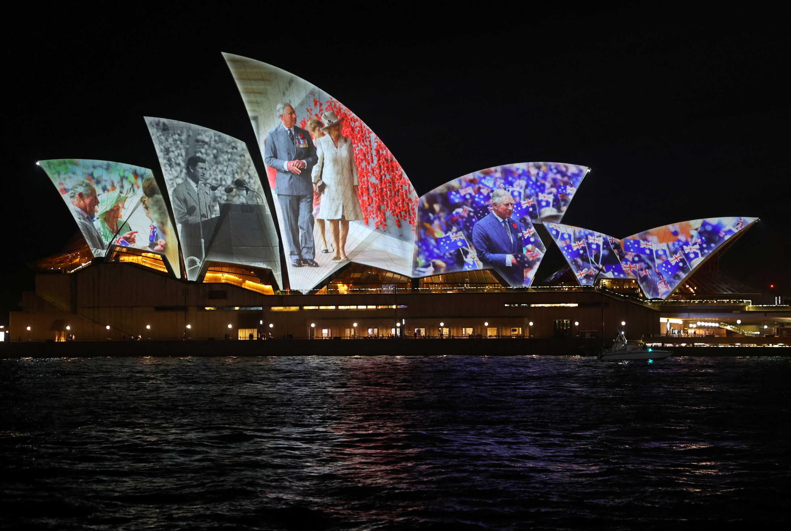 Images of Britain's King Charles and Queen Camilla during previous visits to Australia are projected onto Sydney Opera House, as they arrive for their current visit, in Sydney, Australia, October 18, 2024. REUTERS