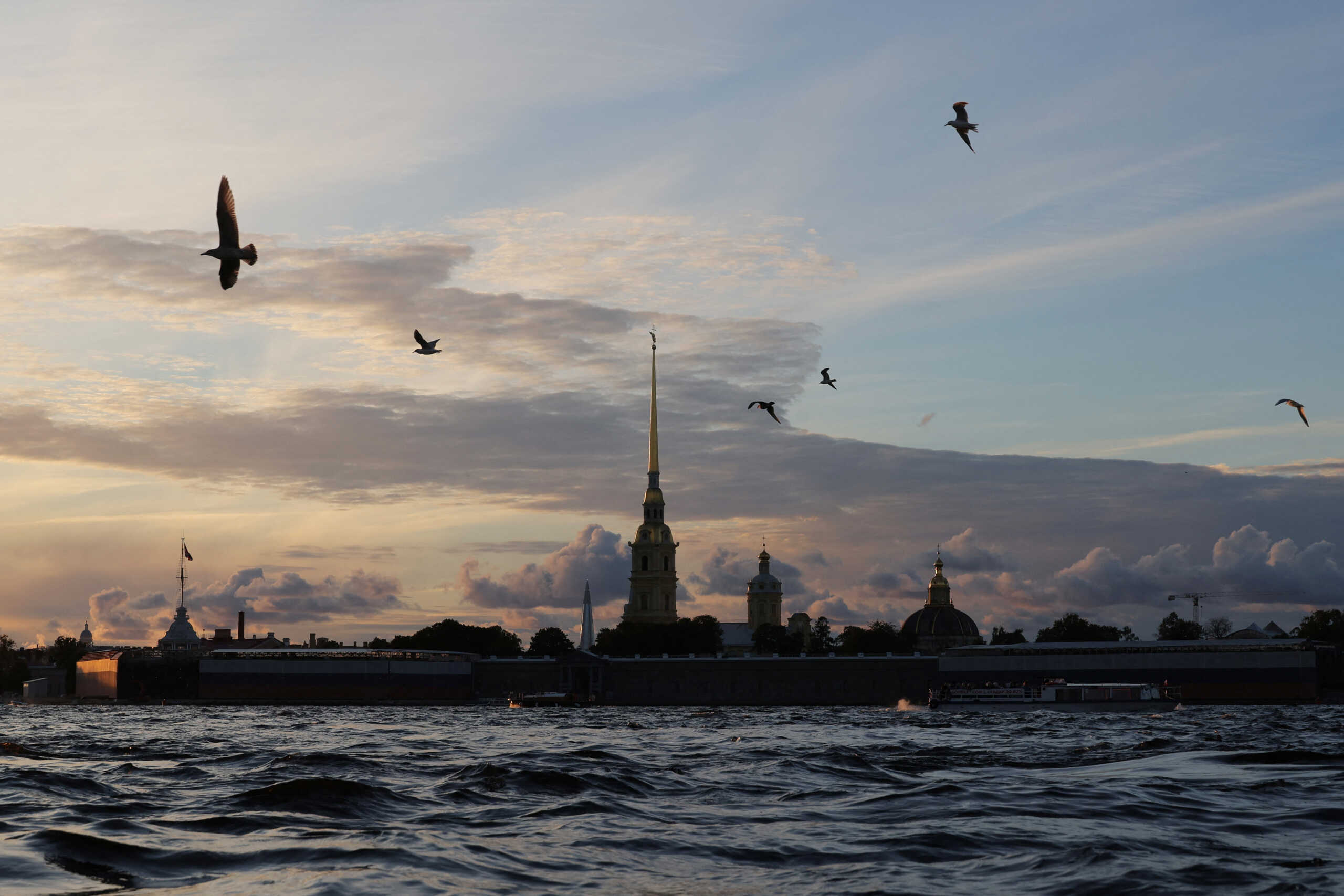 Birds fly over the Neva river with the Peter and Paul cathedral in the background during sunset in central Saint Petersburg, Russia September 22, 2024.  REUTERS