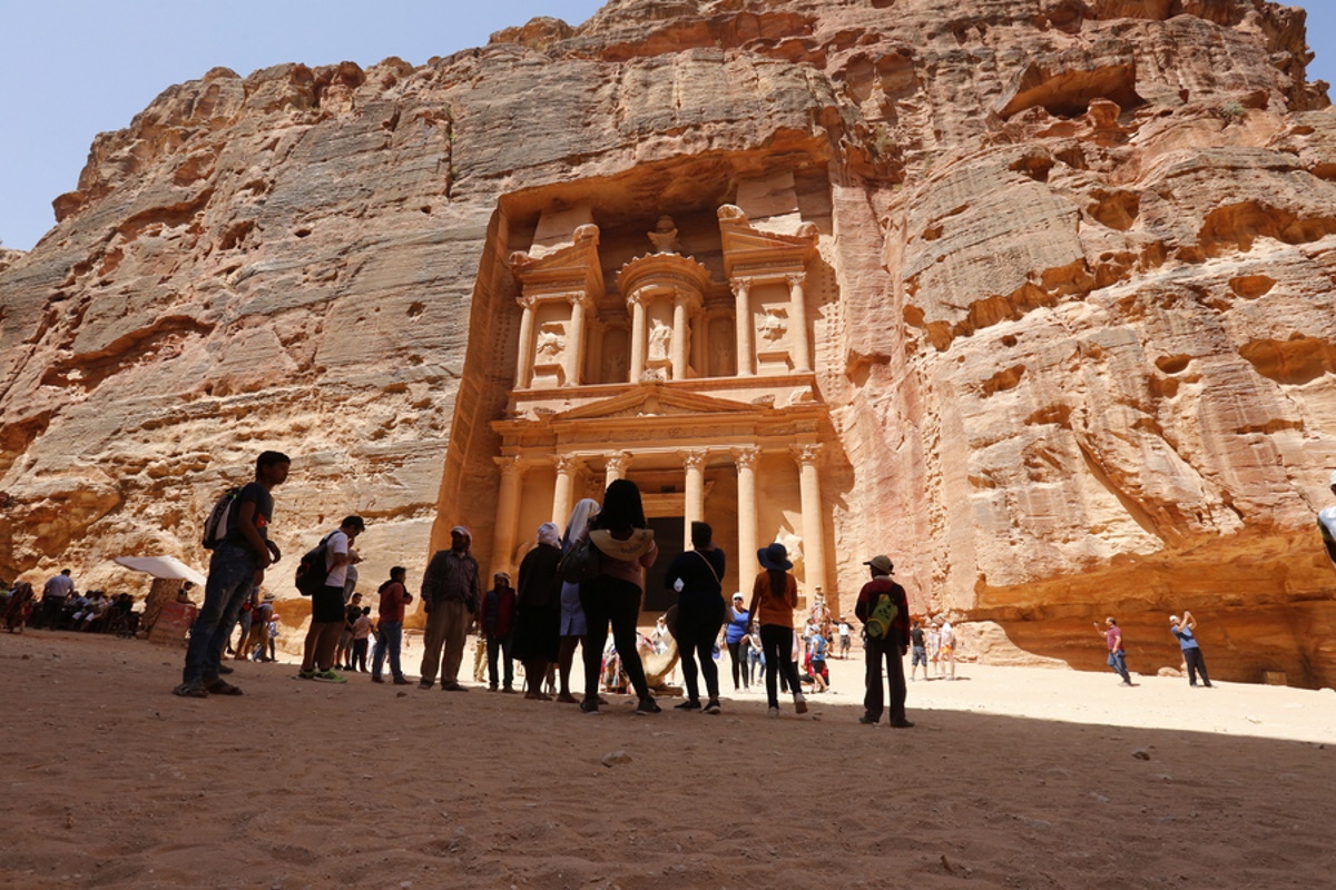 epa06918244 Tourists visit a famous monument, the Treasury, at the rock-carved rose-red city of Petra, Jordan, 27 July 2018 (issued on 29 July 2018). Jordan’s ancient city of Petra, one of the most famous archaeological sites in the world, is believed to have been settled as early as 9,000 BC, and it possibly began to prosper as the capital of the Nabataean Empire from the 1st century BC. Petra is designated a World Heritage Site since 1985.  EPA