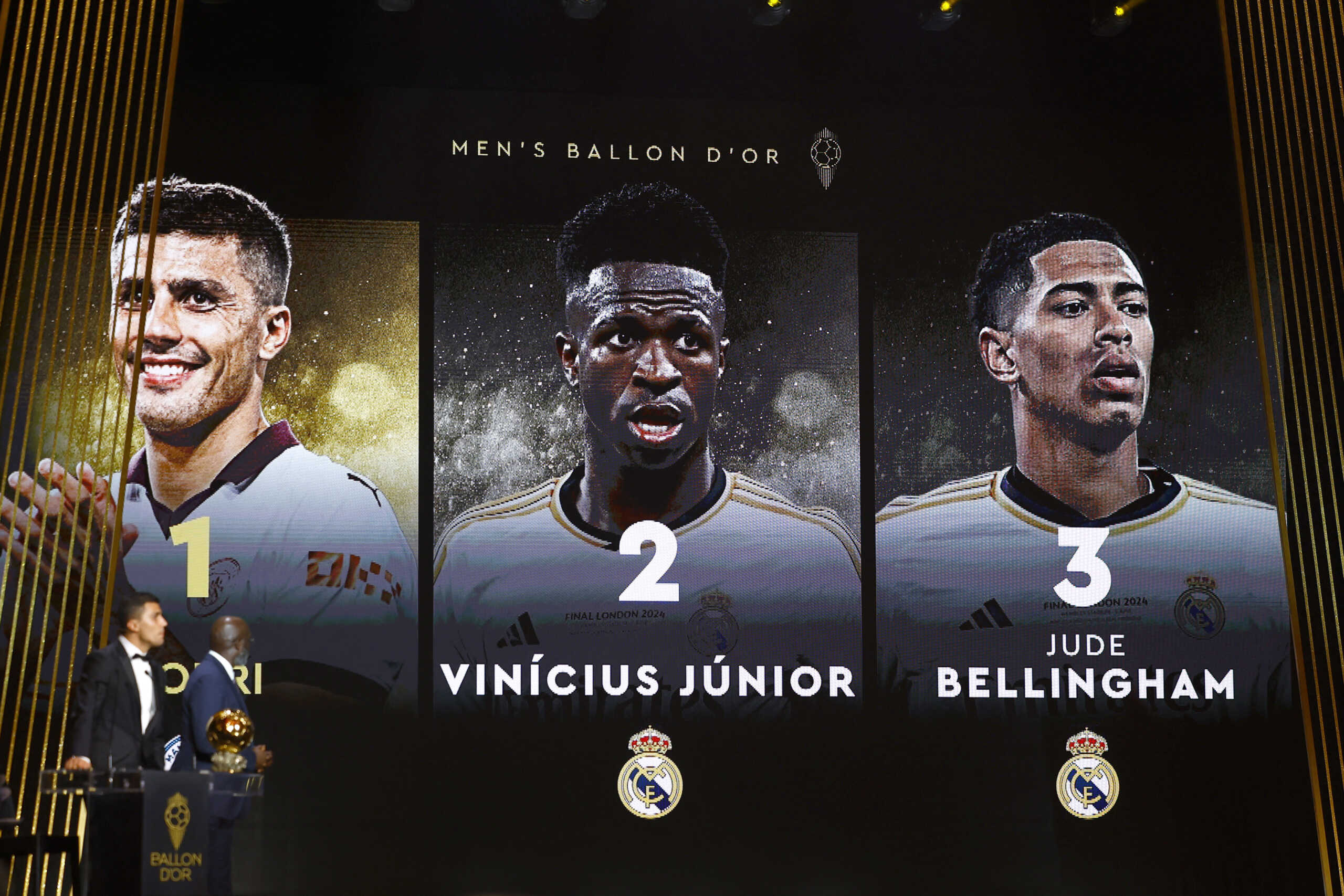 Soccer Football - Ballon d'Or - Theatre du Chatelet, Paris, France - October 28, 2024 Spain's and Manchester City's Rodri receives the Ballon d'Or from George Weah as showing on the screen the second Vinicius Junior and third and Jude Bellingham, no Real Madrid member attended the ceremony REUTERS