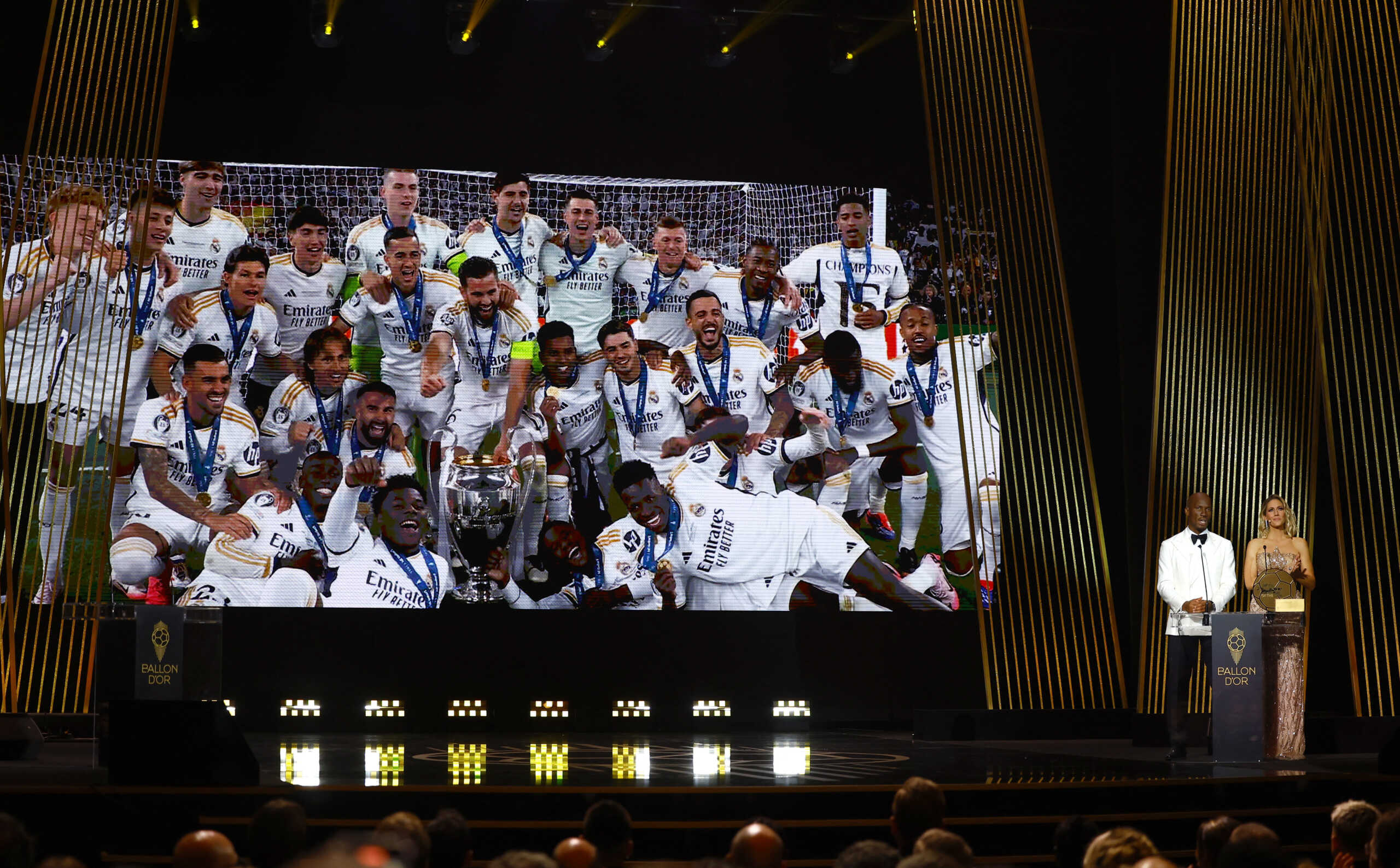 Soccer Football - Ballon d'Or - Theatre du Chatelet, Paris, France - October 28, 2024 Didier Drogba with Sandy Heribert present club men team of the year to Real Madrid REUTERS