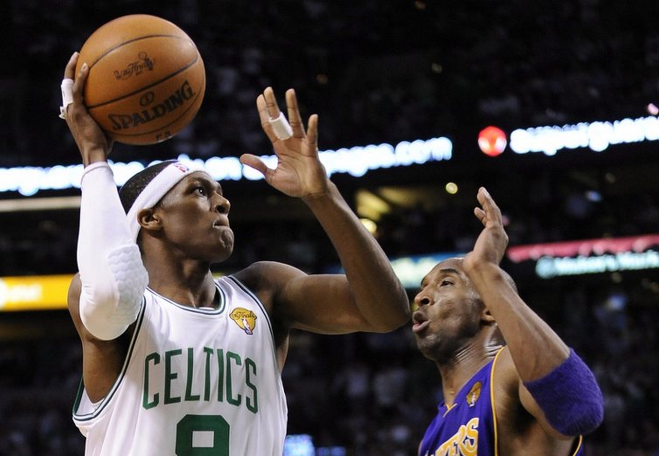 epa02196044 Boston Celtics player Rajon Rondon (L) takes a shot against Los Angeles Lakers player Kobe Bryant (R) during the second half of game four of the NBA Finals at TD Gardens in Boston, Massachusetts, USA, 10 June 2010. The Lakers lead the series over the Celtics 2-1.  EPA