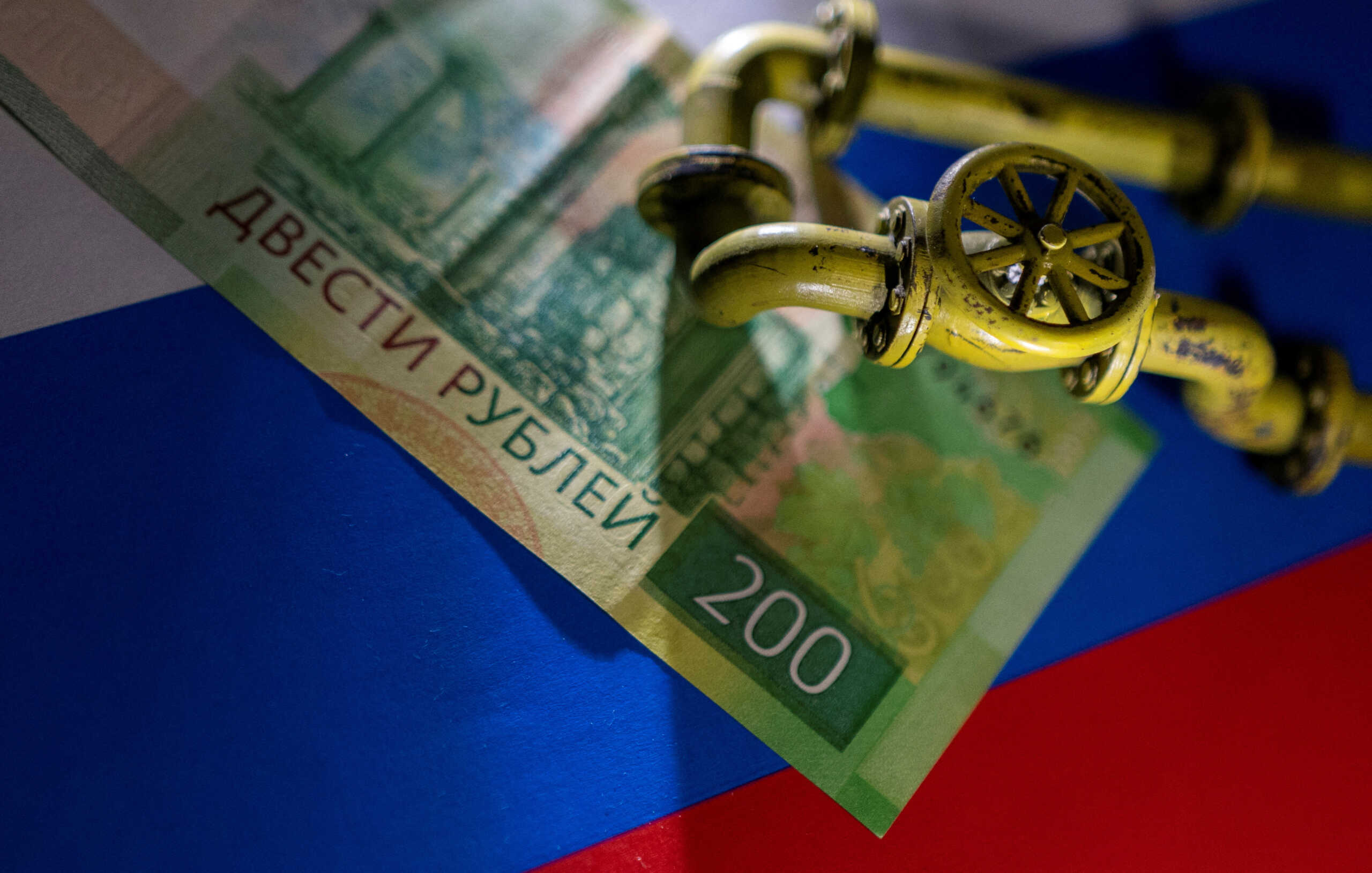 FILE PHOTO: A model of the natural gas pipeline is placed on Russian Rouble banknote and a flag in this illustration taken, March 23, 2022. REUTERS