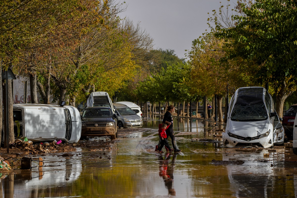 People cross flooded streets in Utiel, Spain, Wednesday, Oct. 30, 2024. (AP Photo