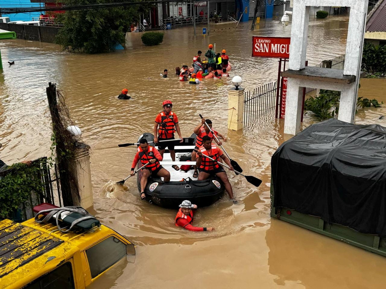 Philippine Coast Guard personnel evacuate residents after flood waters rose due to heavy rains brought by Tropical Storm Trami in Camarines Sur, Philippines October 24, 2024. Philippine Coast Guard