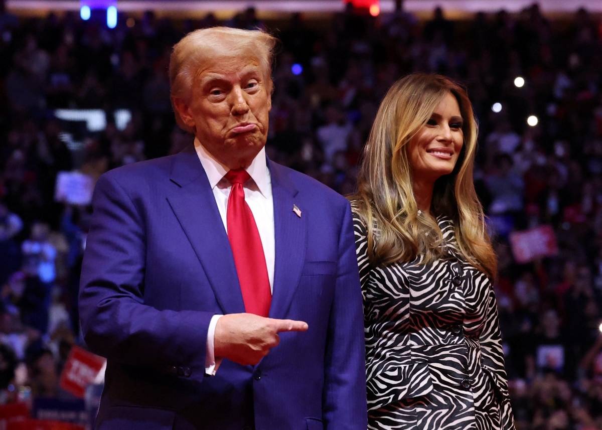 Republican presidential nominee and former U.S. President Donald Trump points his finger next to Melania Trump during a campaign rally at Madison Square Garden, in New York, U.S., October 27, 2024. REUTERS