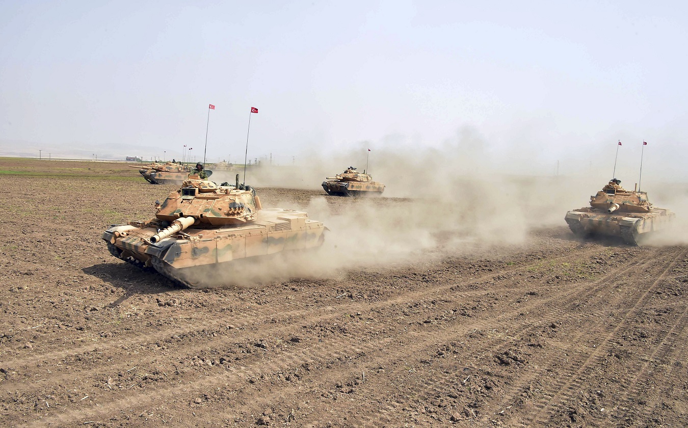 In this photo taken Saturday, Sept. 23, 2017, Turkish army tanks move during maneuvers in Silopi, near Habur border gate with Iraq, southeastern Turkey. The Turkish parliament on Saturday renewed a bill allowing the military to intervene in Iraq and Syria if faced with national security threats — a move seen as a final warning to Iraqi Kurds to call off their Monday independence referendum. (Turkish Military