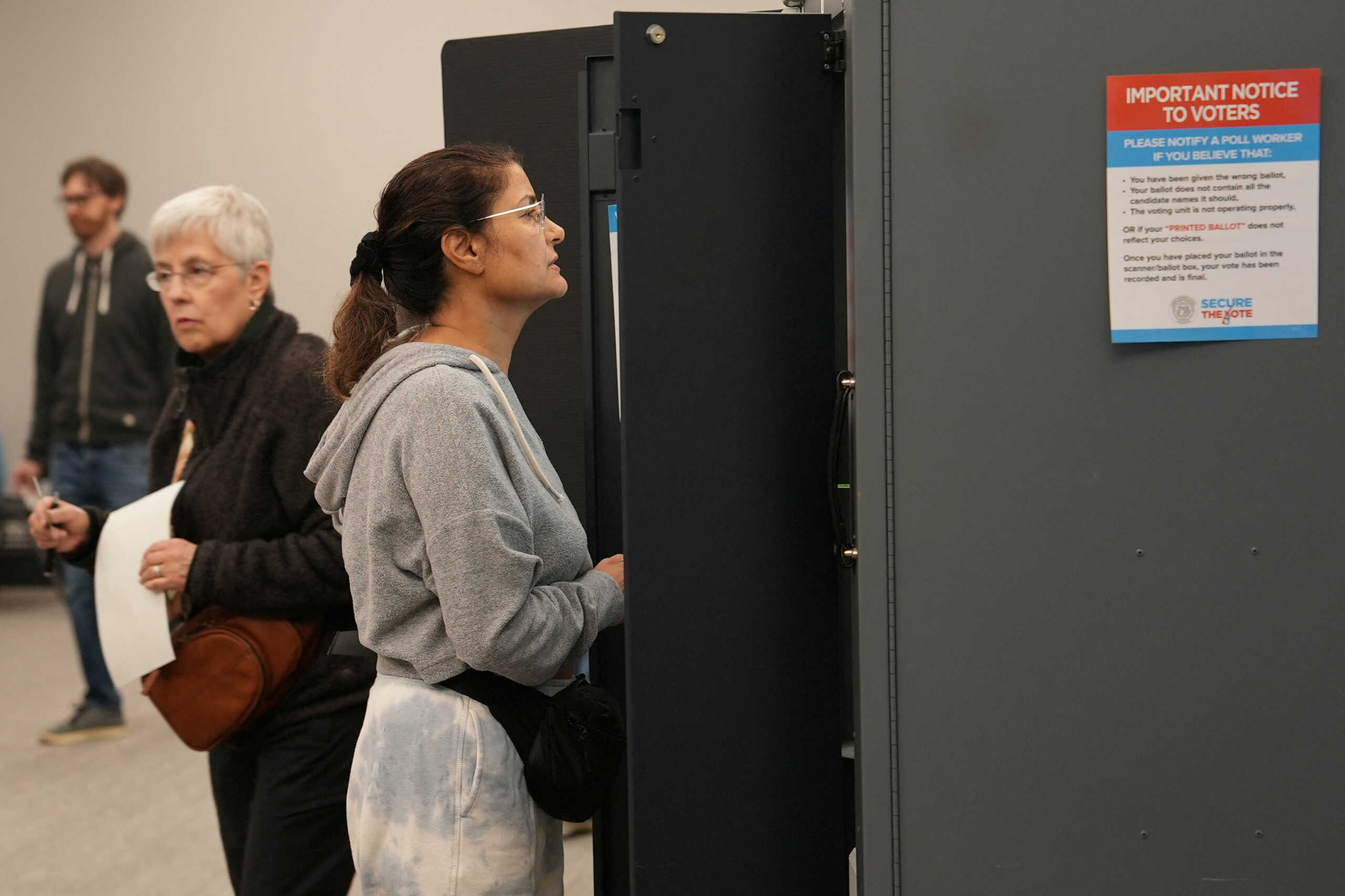 Voters take part in early election voting at a polling station in Marietta, Georgia, U.S. October 15, 2024.  REUTERS