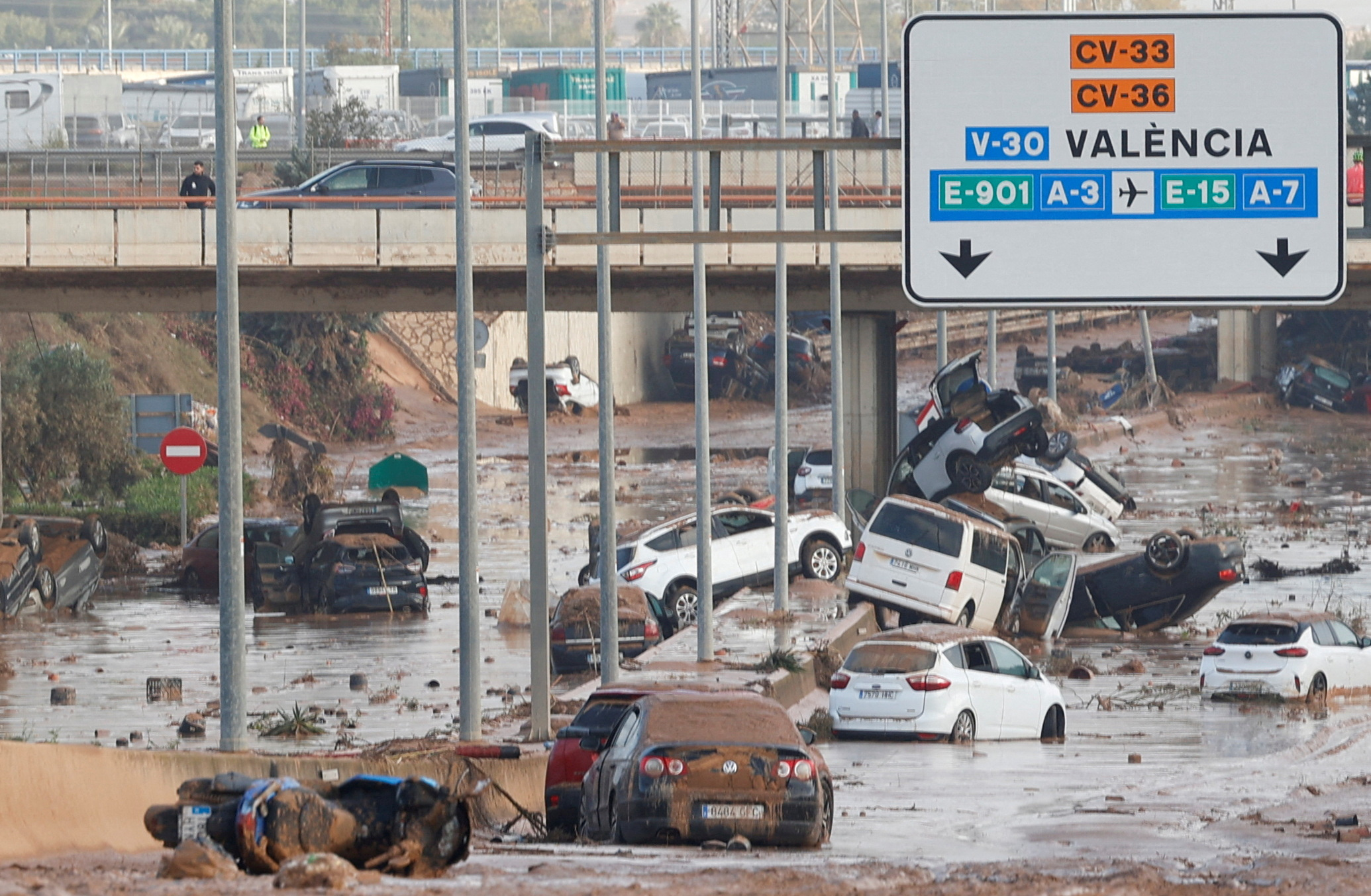 Damaged cars are seen along a road affected by torrential rains that caused flooding, on the outskirts of Valencia, Spain, October 31, 2024. REUTERS