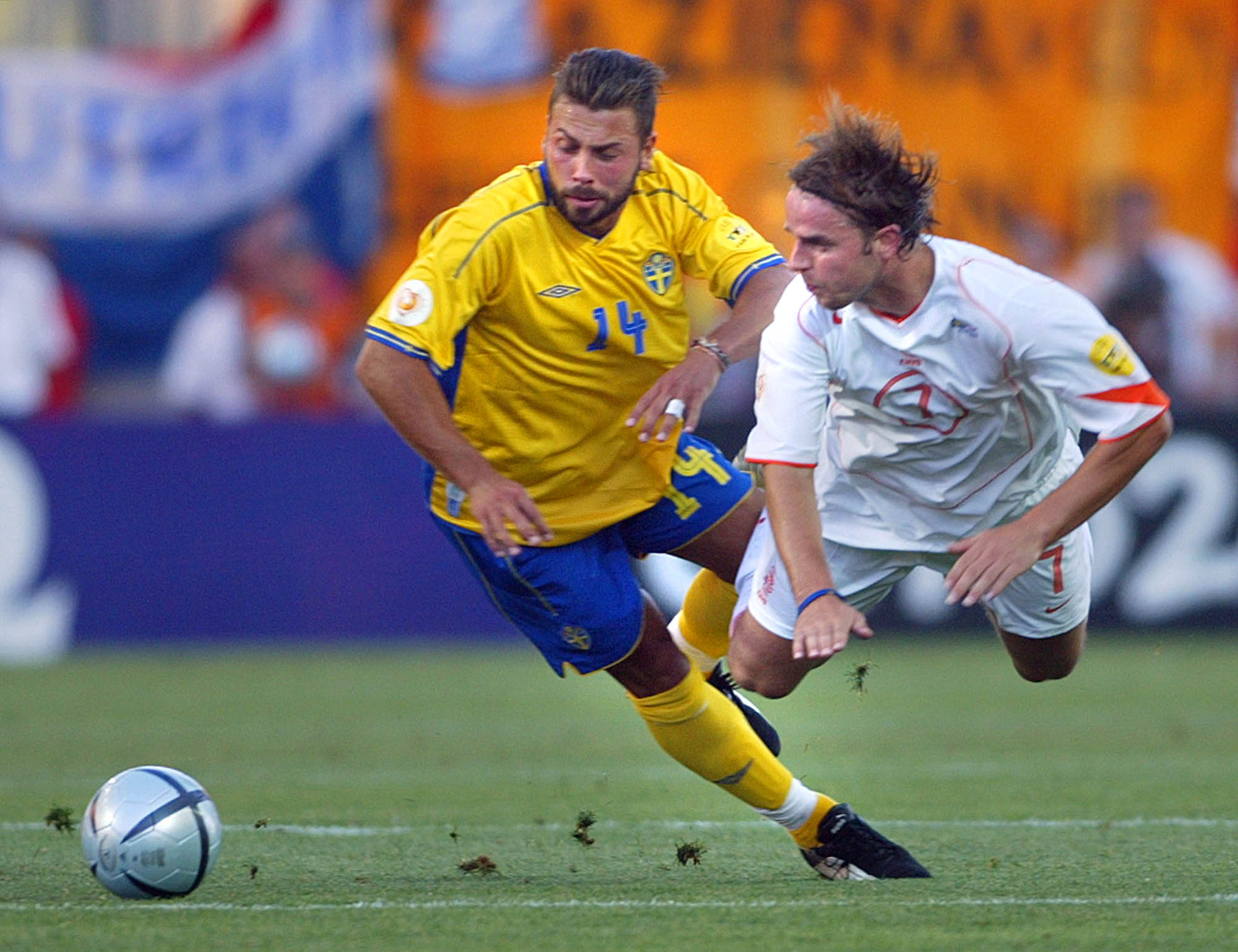 Andy Van Der Meyde, right, of the Netherlands, is fouled by Sweden's Alexander Ostlund during the Euro 2004 quarterfinal soccer match between Sweden and the Netherlands at the Algarve Stadium in Faro, Portugal, Saturday, June 26, 2004. (AP Photo