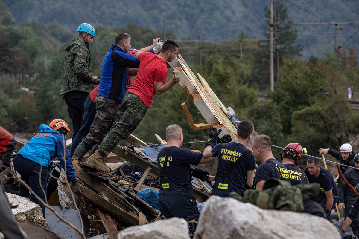 Rescue workers try to remove debris following a landslide in the flooded village of Donja Jablanica, Bosnia and Herzegovina, October 5, 2024.REUTERS