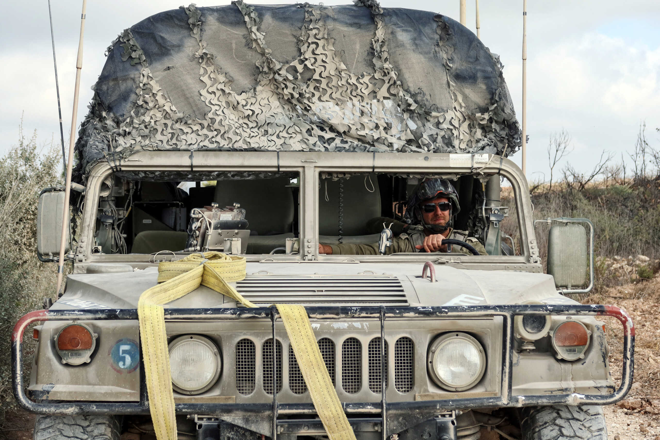 An Israeli soldier drives through southern Lebanon, as part of an incursion during hostilities between Hezbollah and Israel, October 13, 2024. REUTERS