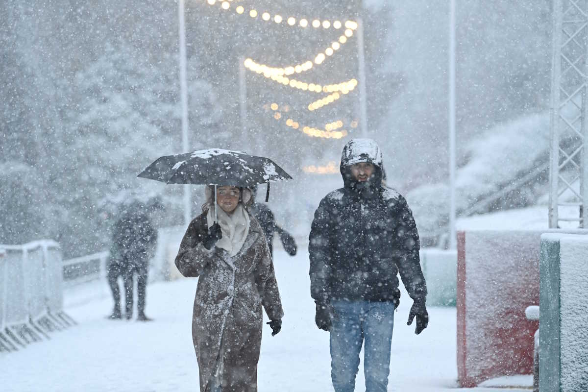People walk through the snowfall during Storm Bert, along Princes Street Gardens in Edinburgh, Scotland, Britain, November 23, 2024. REUTERS