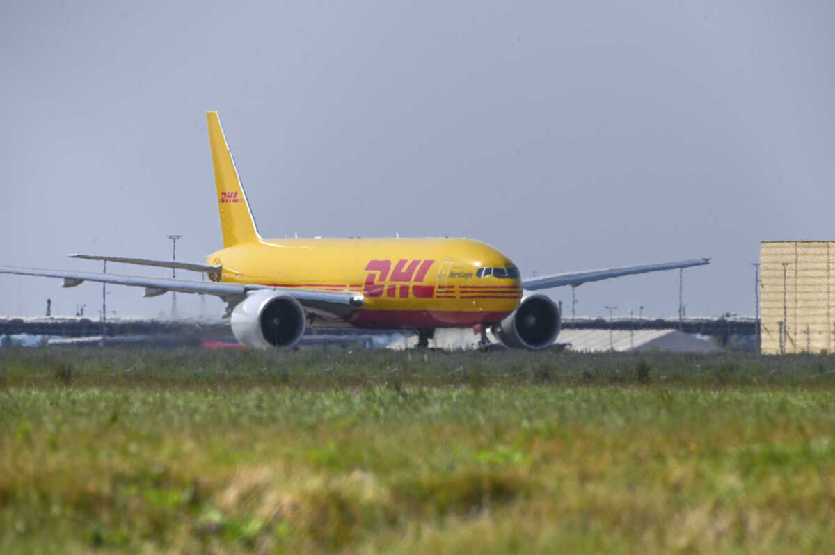 30 August 2024, Saxony, Schkeuditz: A DHL aircraft in front of the DHL Air Hub at Leipzig