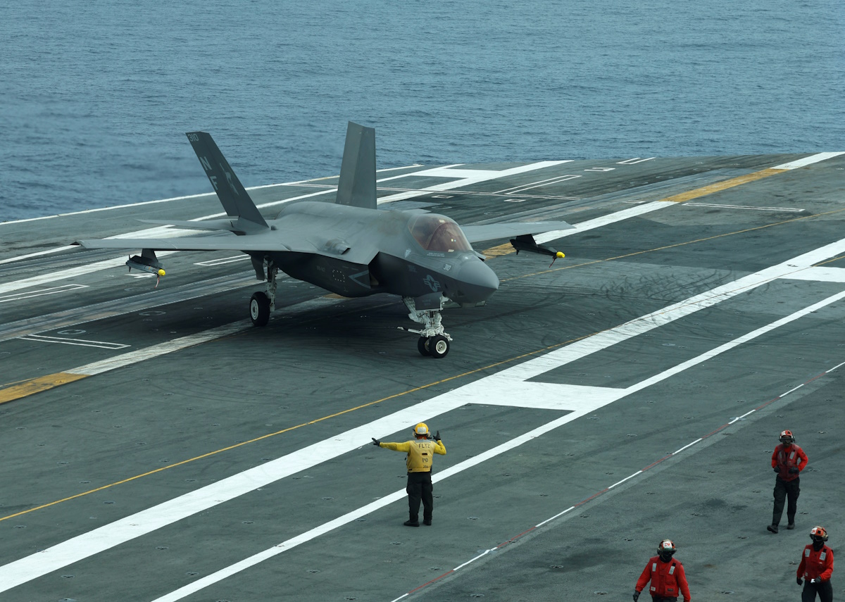 A flight deck crew signal to F-35 jet on USS George Washington during Freedom Edge trilateral exercise among United States, Japan and South Korea in the East China Sea, south of the Korean peninsula and west of Japan's main islands November 14, 2024. REUTERS