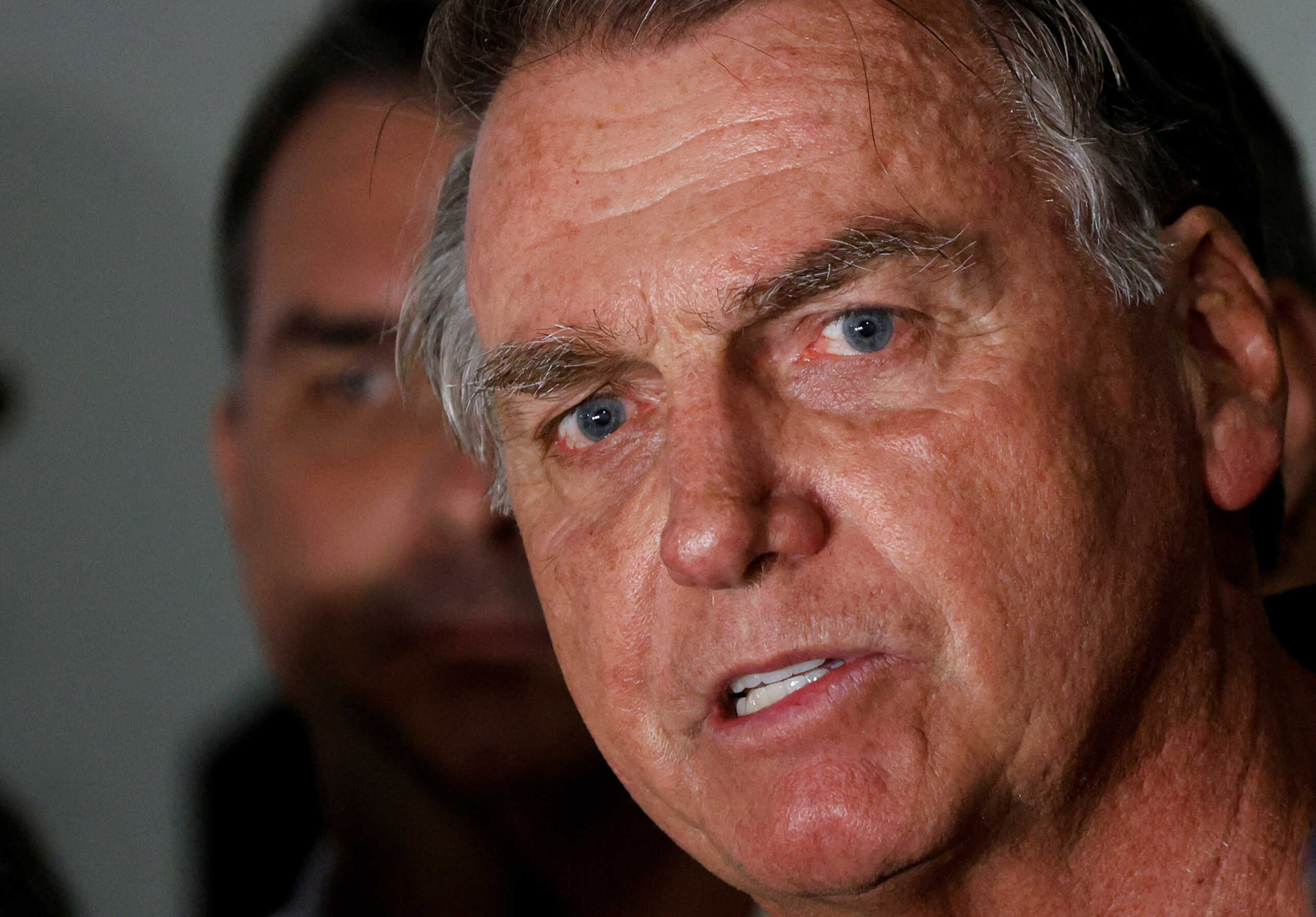 Brazil's former President Jair Bolsonaro talks with media upon his arrival at Brasilia International Airport, in Brasilia, Brazil November 25, 2024. REUTERS