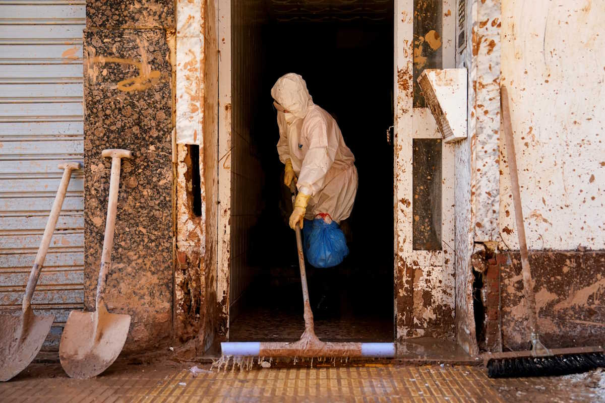 A person sweeps mud from a house, in the aftermath of the flooding caused by heavy rains in Catarroja, near Valencia, Spain November 10, 2024. REUTERS