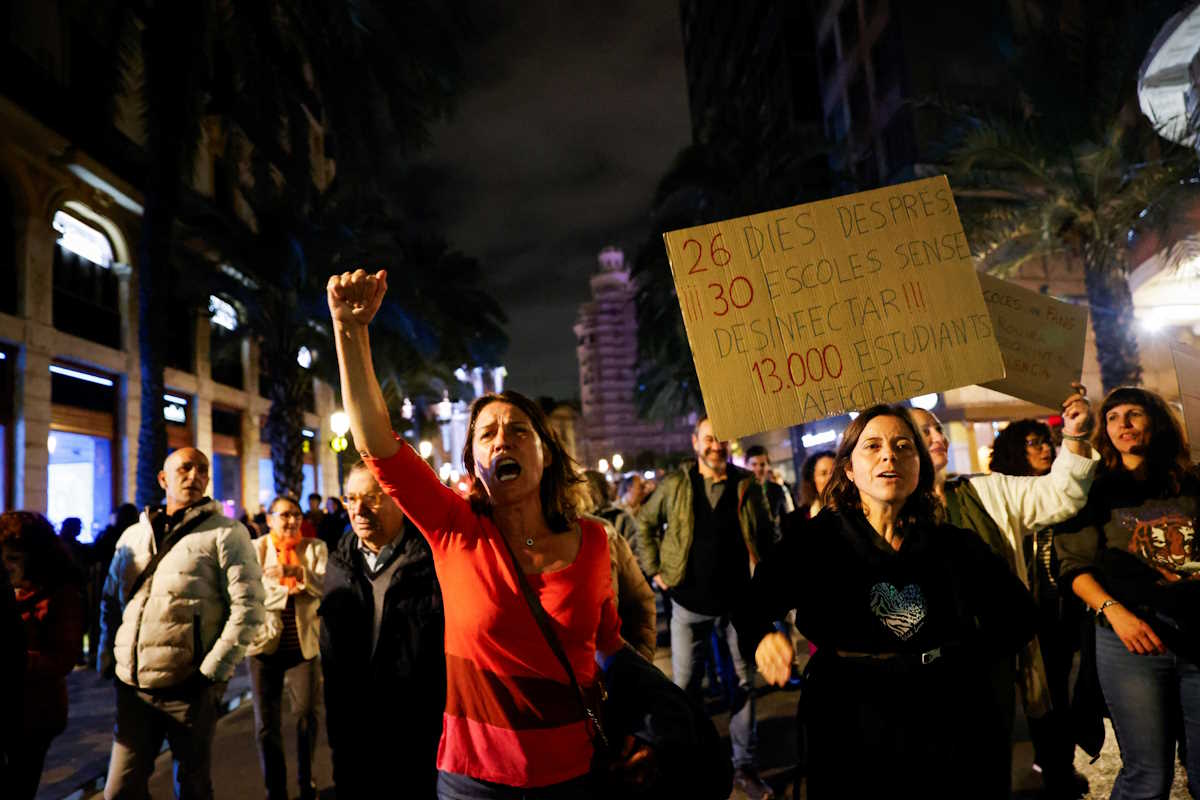 People hold placards as unions, teachers and families protest against the management of the emergency response in education after deadly floods in eastern Spain, in Valencia, Spain, November 23, 2024. REUTERS