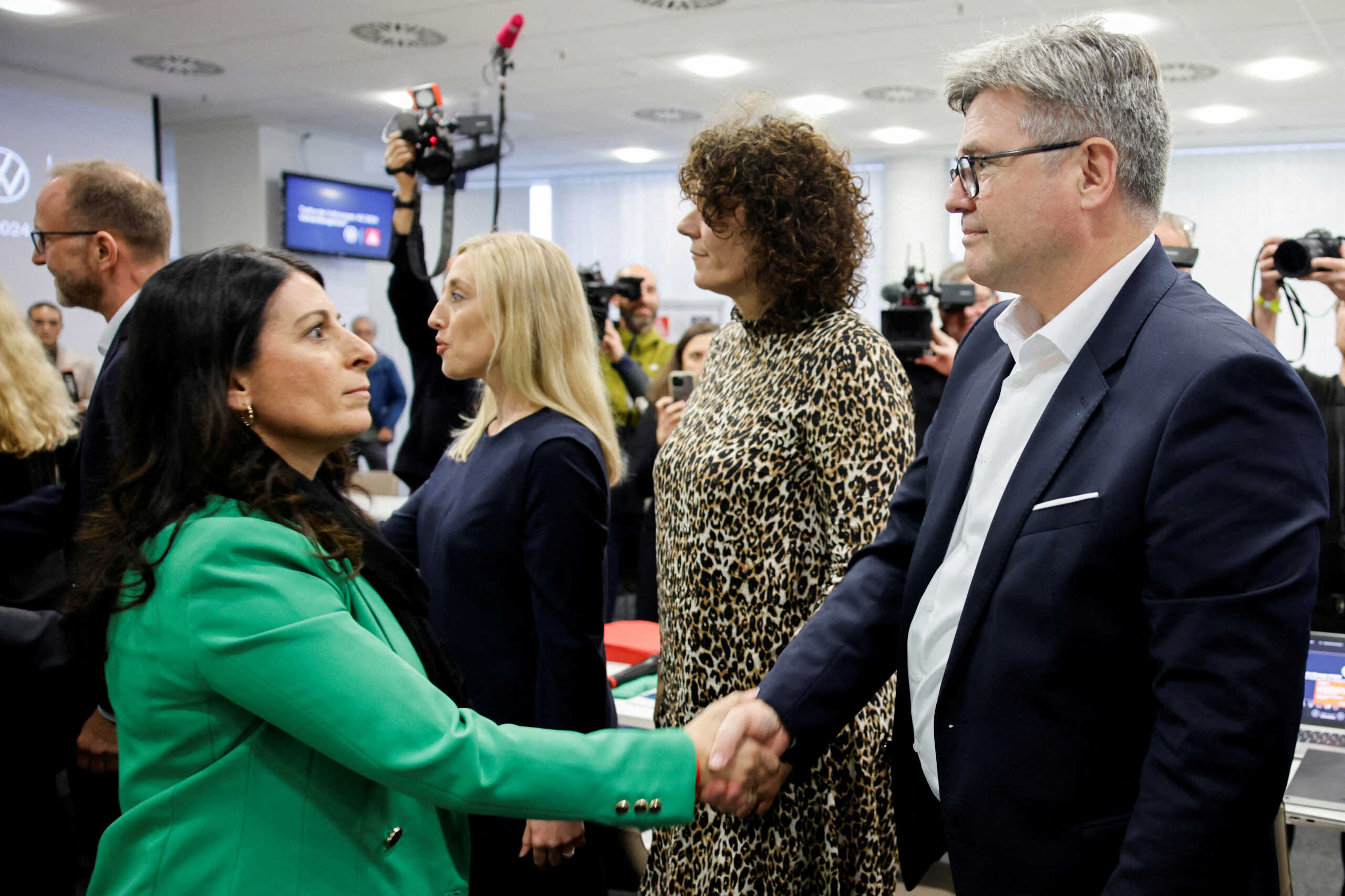 FILE PHOTO: Arne Meiswinkel, board member for human resources of Volkswagen Passenger Cars, shakes hands with Daniela Cavallo, chairwoman of the general and group works council of Volkswagen AG, during the second round of collective bargaining negotiations between Volkswagen and the IG Metall union in Wolfsburg, Germany October 30, 2024. REUTERS