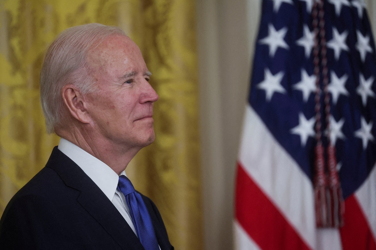 FILE PHOTO: U.S. President Joe Biden awaits his turn to speak about infrastructure jobs and job training in broadband, construction, and manufacturing following passage of the Bipartisan Infrastructure Law, the CHIPS and Science Act and the Inflation Reduction Act, during an event in the East Room of the White House in Washington, U.S., November 2, 2022. REUTERS