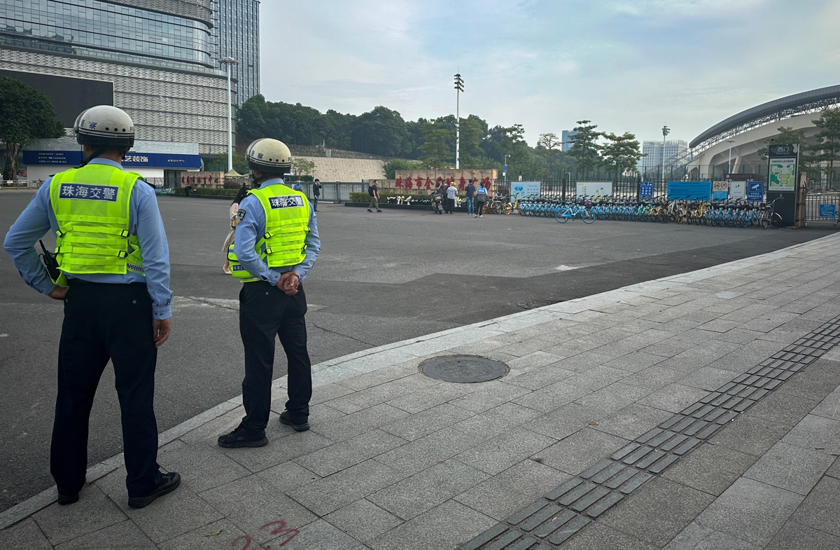 Police officers stand outside a sports centre where a deadly car attack took place, in Zhuhai, Guangdong province, China November 13, 2024. REUTERS