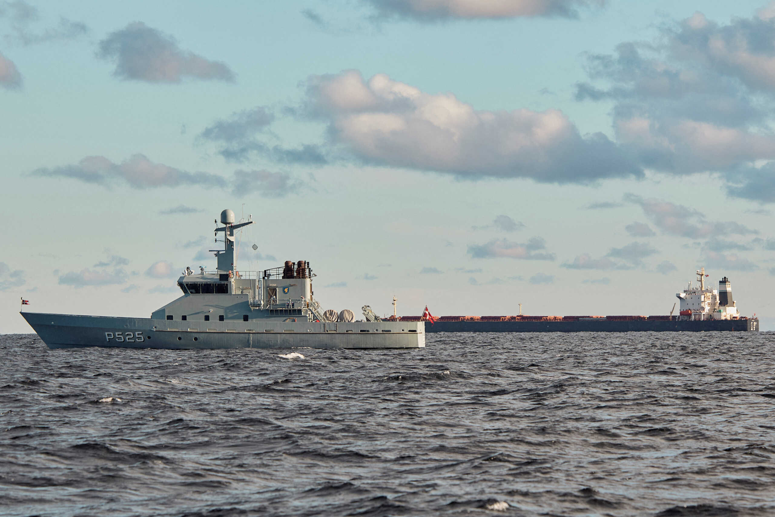 The Chinese ship, the bulk carrier Yi Peng 3, in background, is anchored and being monitored by a Danish naval patrol vessel, mid-sea in the Kattegat, Denmark, November 20, 2024. Ritzau Scanpix