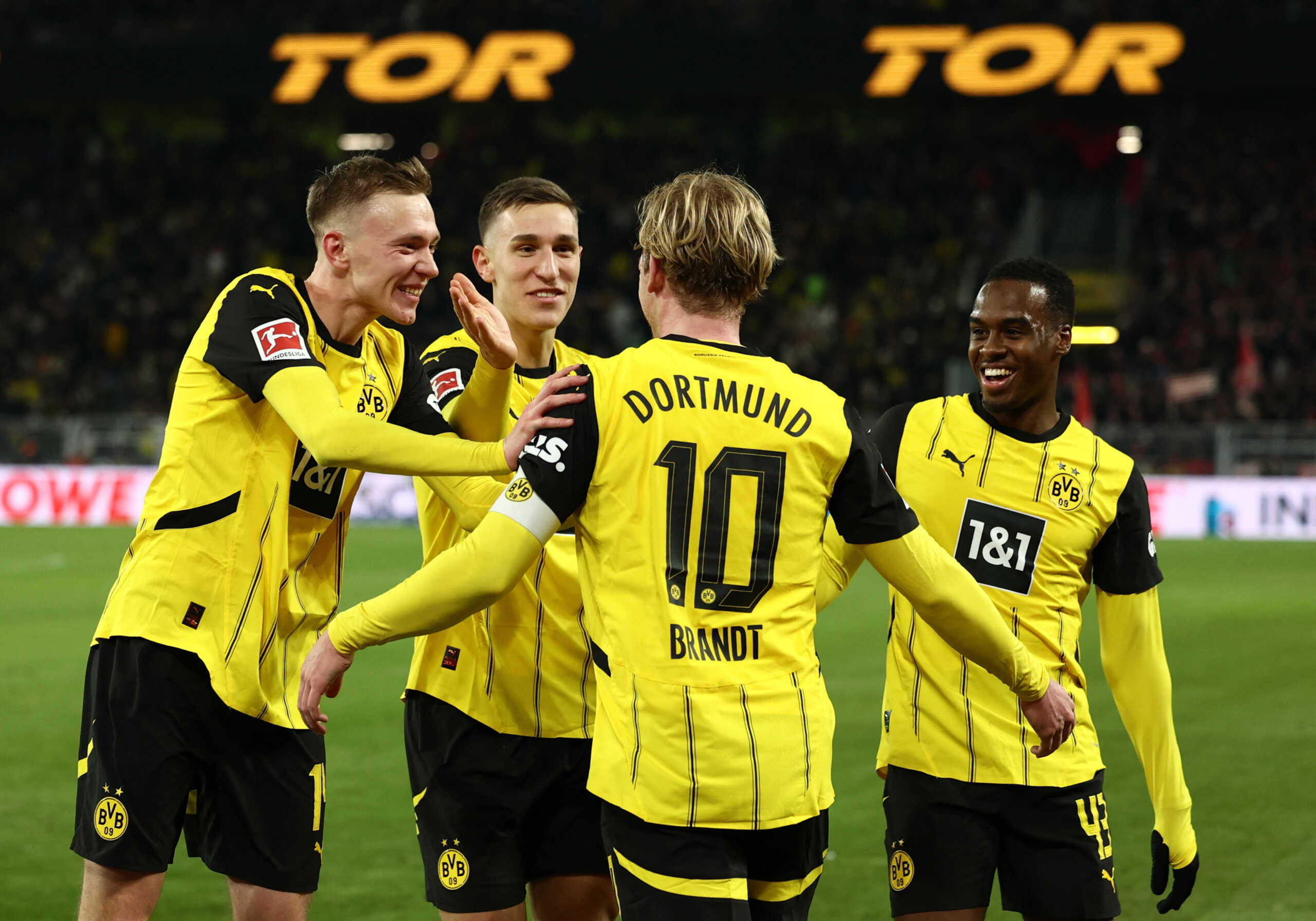 Soccer Football - Bundesliga - Borussia Dortmund v SC Freiburg - Signal Iduna Park, Dortmund, Germany - November 23, 2024 Borussia Dortmund's Julian Brandt celebrates scoring their third goal with Jamie Bynoe-Gittens and teammates REUTERS