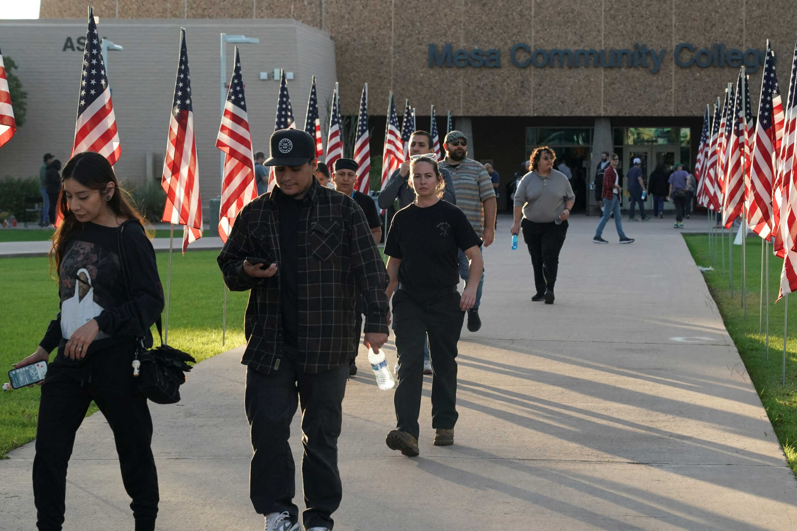Voters walk away fron the polling station outside Mesa Community College in Mesa, Arizona, U.S., November 5, 2024. REUTERS