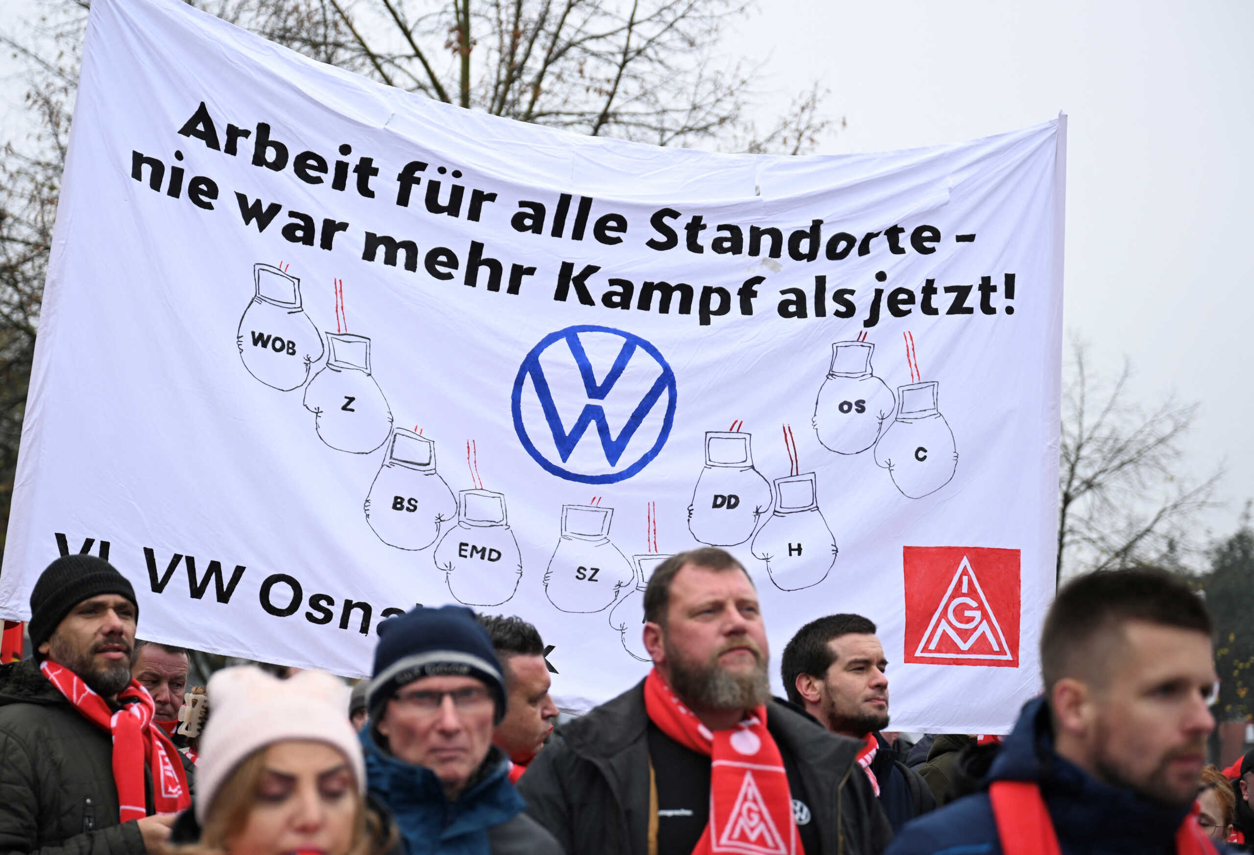 Employees of Volkswagen AG march for higher wages during a 'warning strike' of Germany's IG Metall metalworkers' union, in Osnabrueck, Germany, November 6, 2024. The placard reads, “Jobs for all VW sites - there has never been more fight than now”. REUTERS