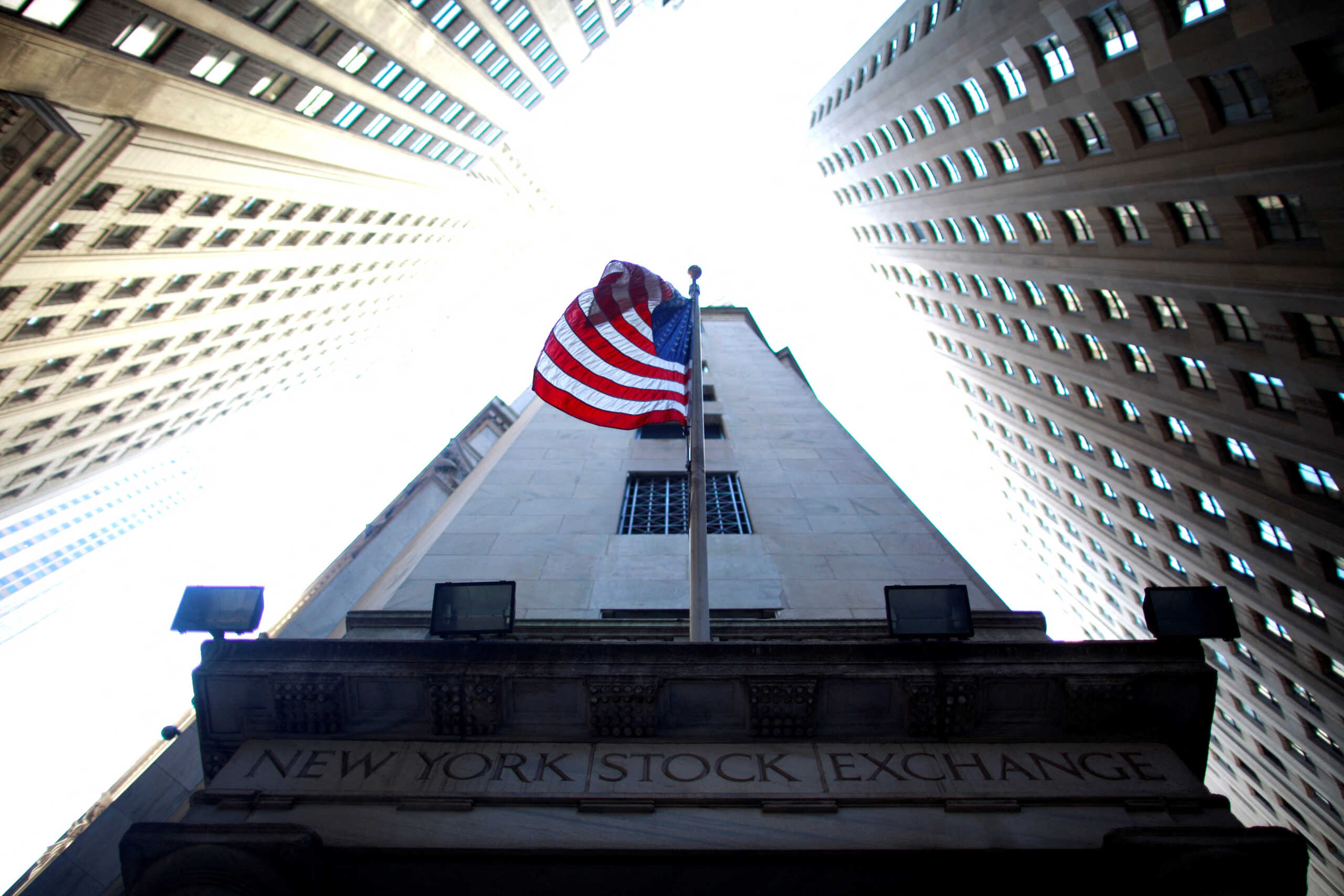 FILE PHOTO: A flag flies at the exterior of New York Stock Exchange June 15, 2012. REUTERS